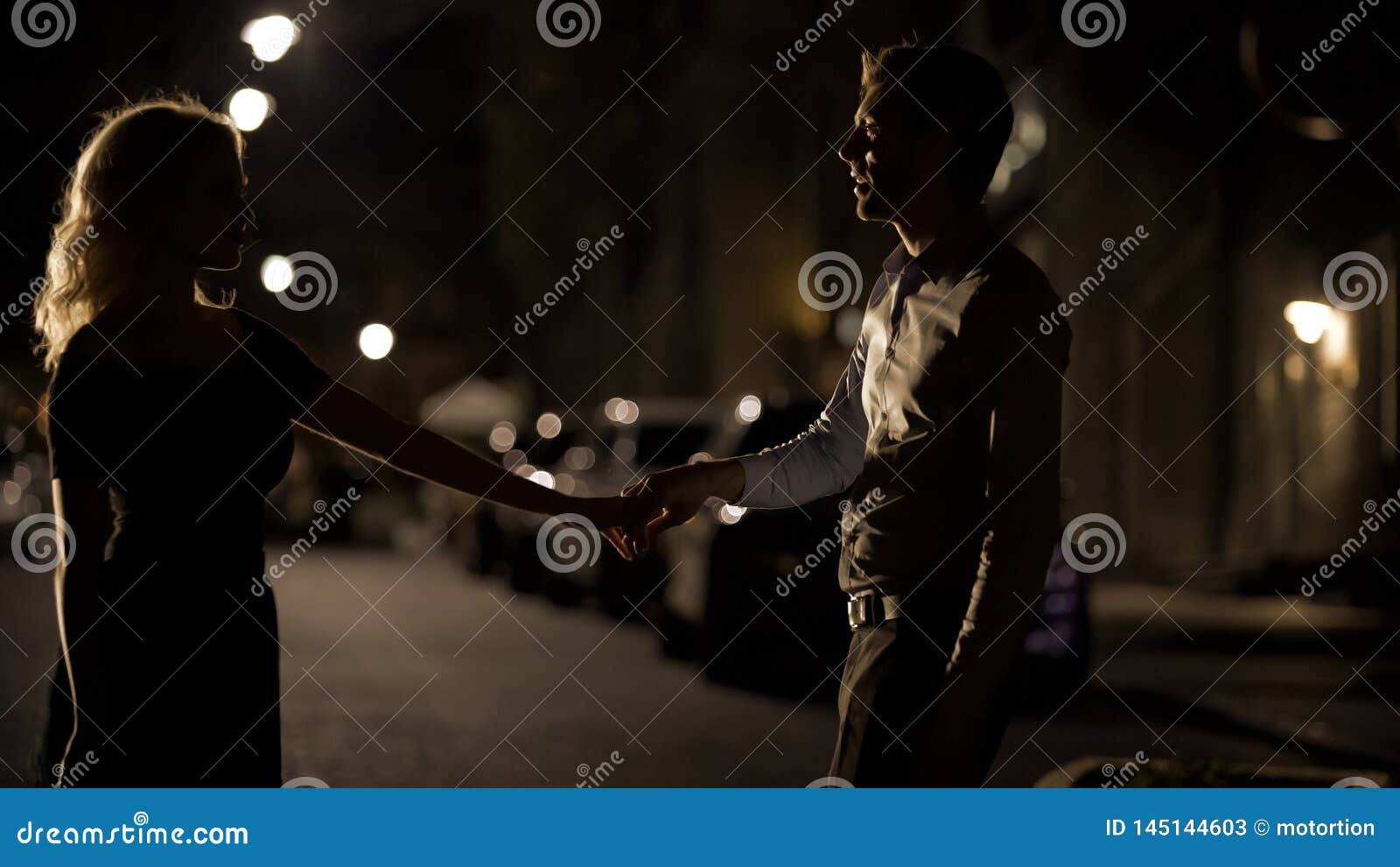 couple of lovers dancing in empty night street, dating and love, seduction