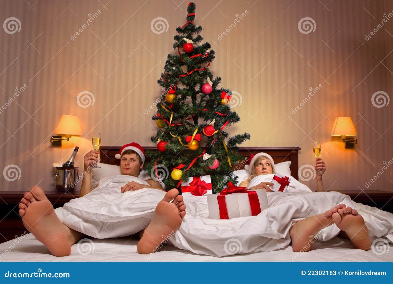 Couple Lying on Bed with Christmas Tree Stock Image Image of female