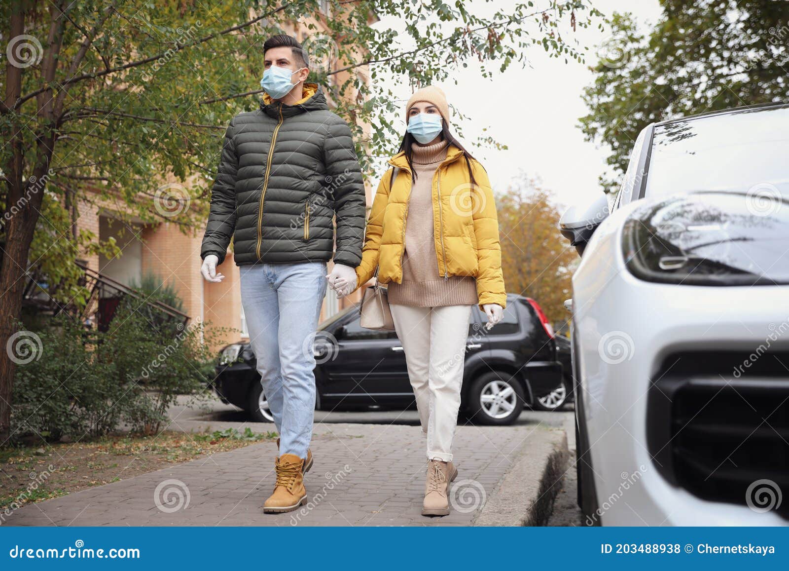Couple in Medical Face Masks and Gloves Walking Outdoors. Personal ...