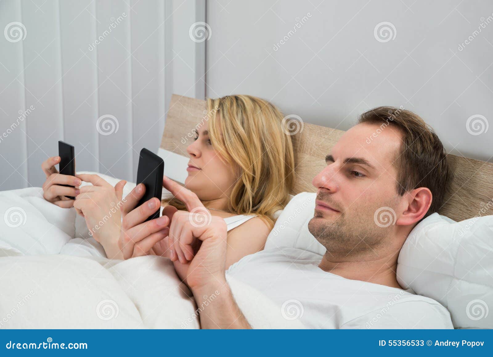 Couple with Mobile Phones in Bed Stock Image Image of mobile, information 55356533