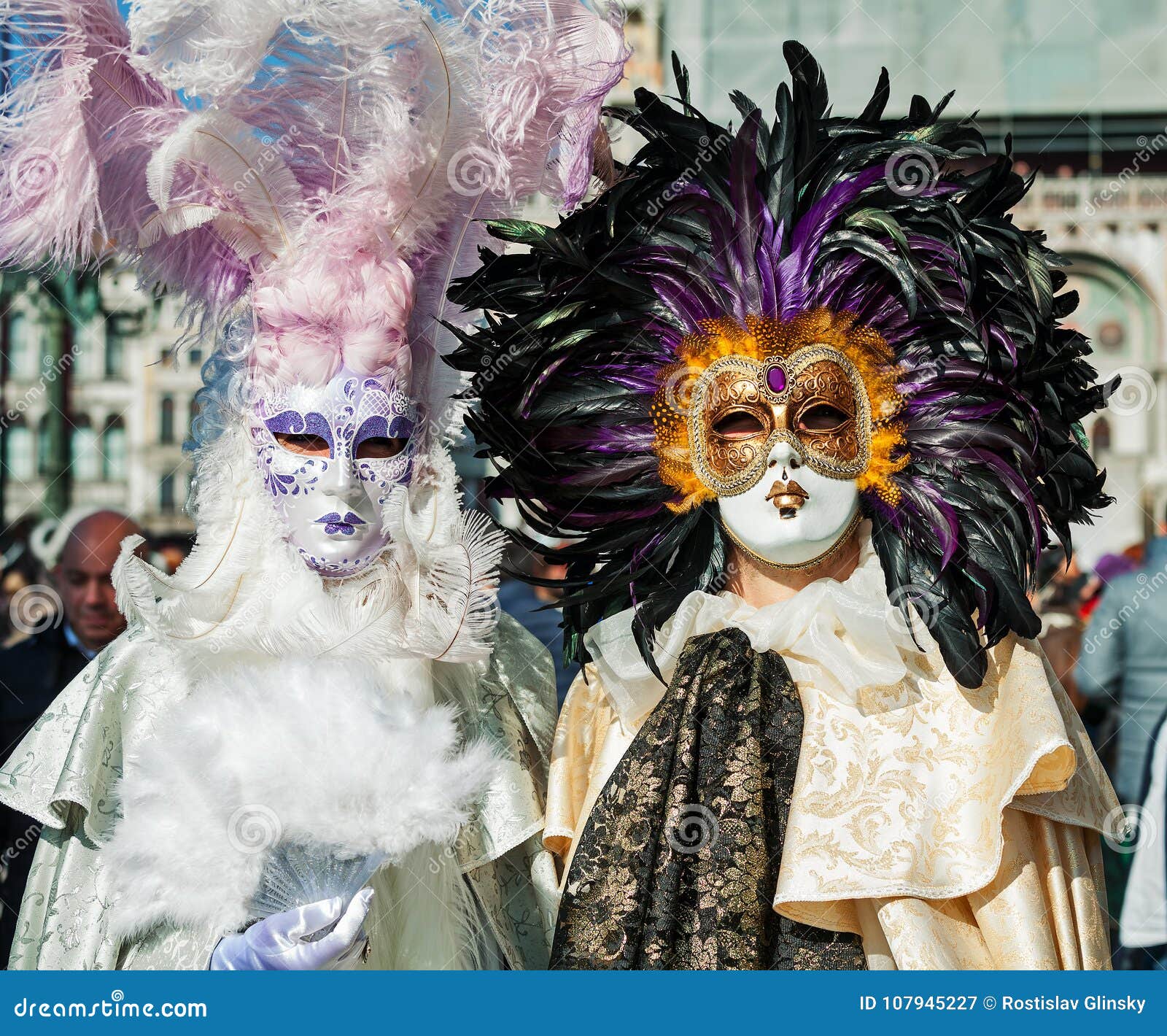 A woman in a feather Venetian mask poses during the Venice