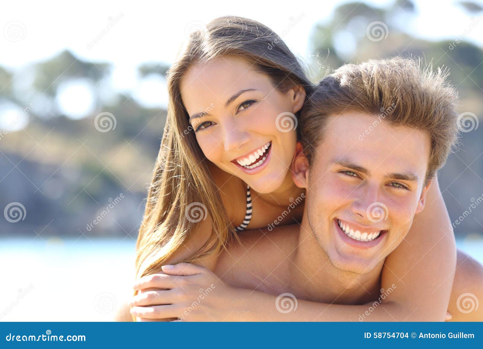 couple with perfect smile posing on the beach