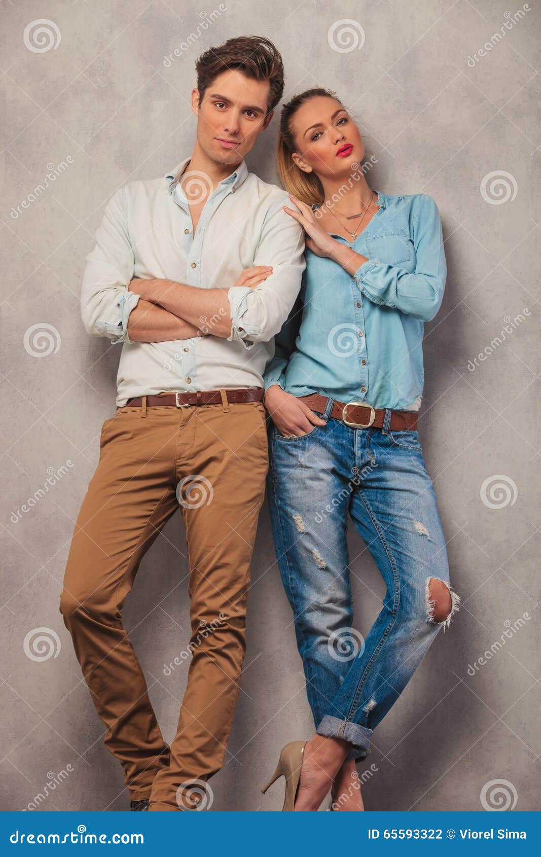 Beautiful Young Smilling Couple Posing Standing In Studio Stock Photo,  Picture and Royalty Free Image. Image 17639903.