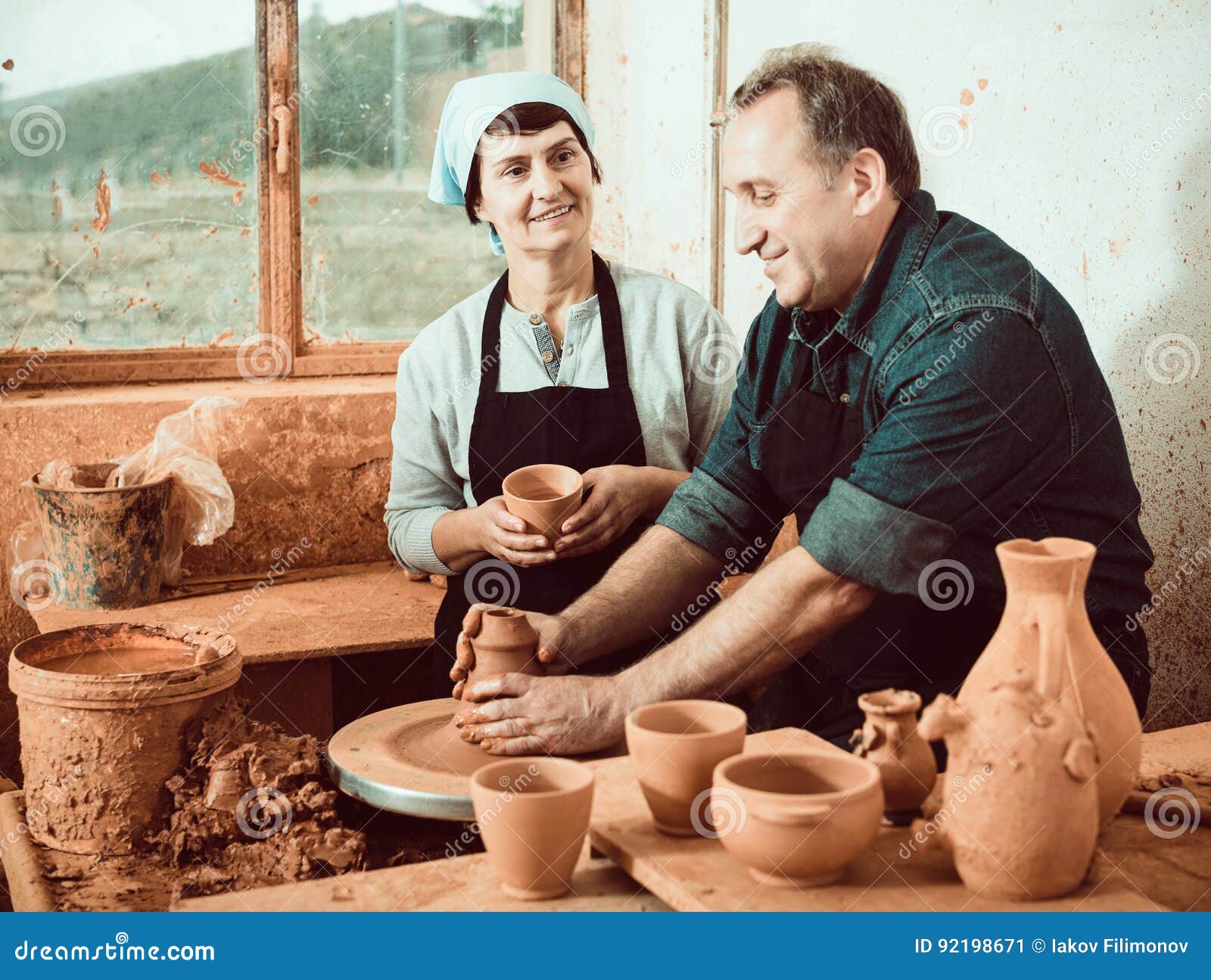 Couple among the pottery stock image. Image of crockery 92198671
