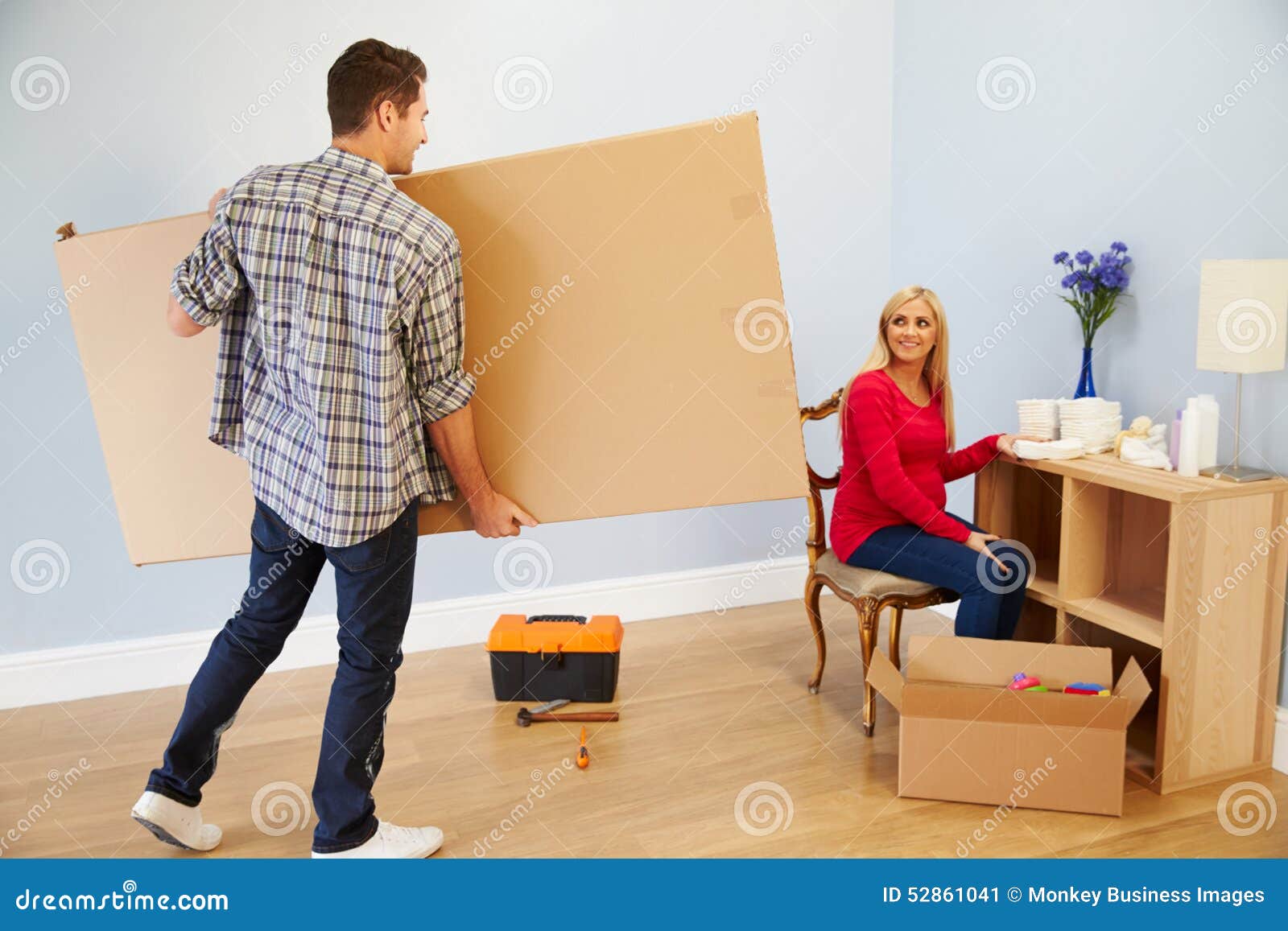 couple preparing to assemble flat pack furniture in nursery