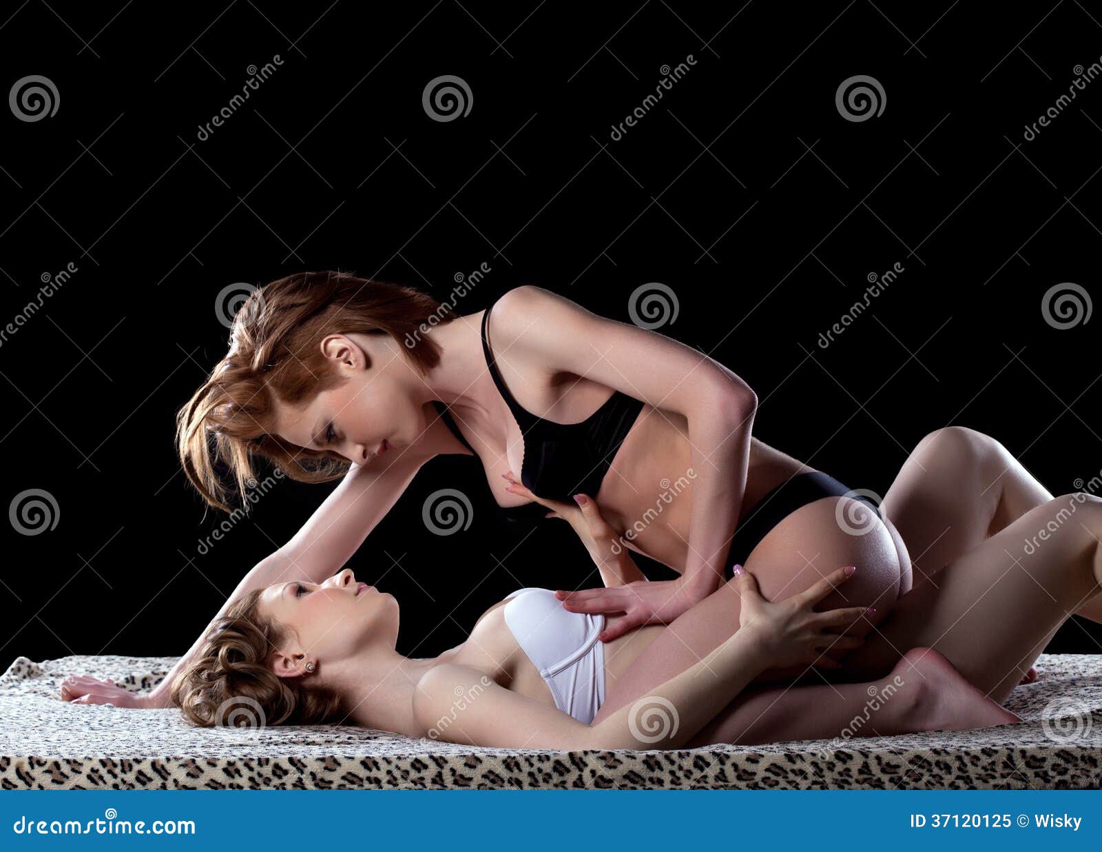 Couple of Pretty Bisexual Girls Lying in Bed Stock Image