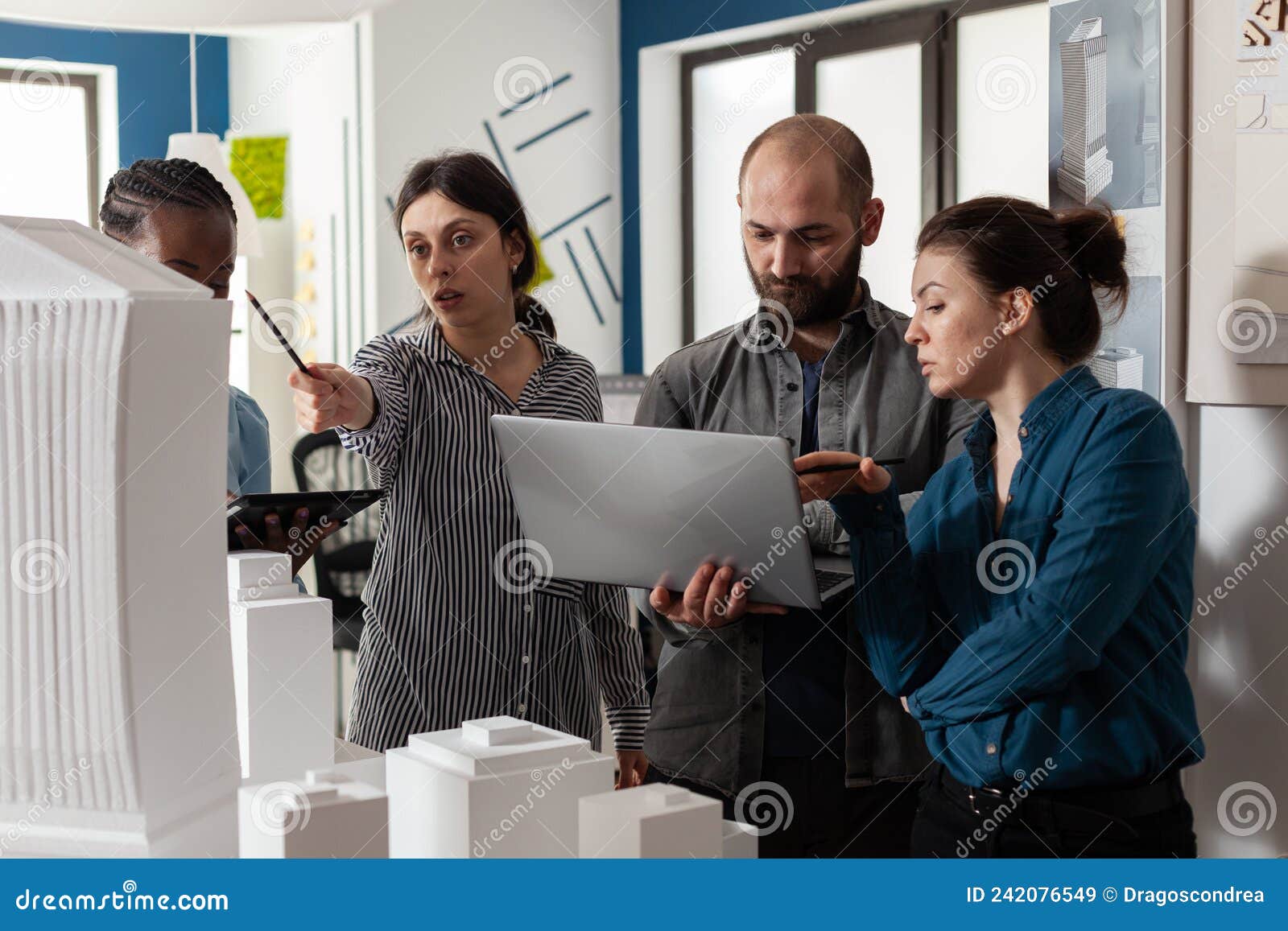 Couple of Professional Architects Holding Laptop Looking at Blueprints ...