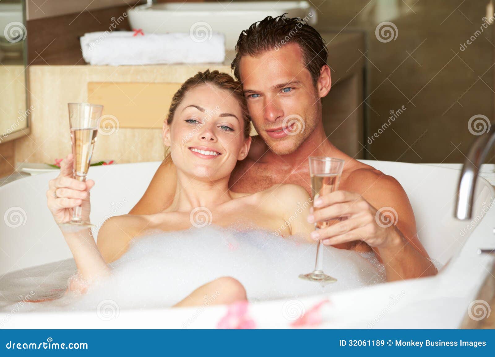 Couple Relaxing In Bath Drinking Champagne Together Royalty Free St