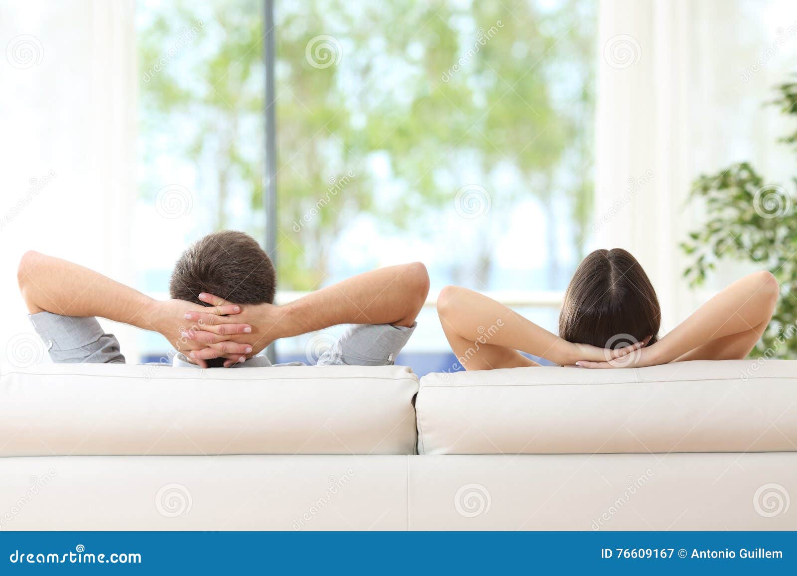 couple relaxing on a couch at home
