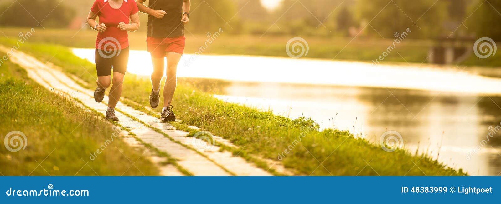 couple running outdoors, at sunset, by a river