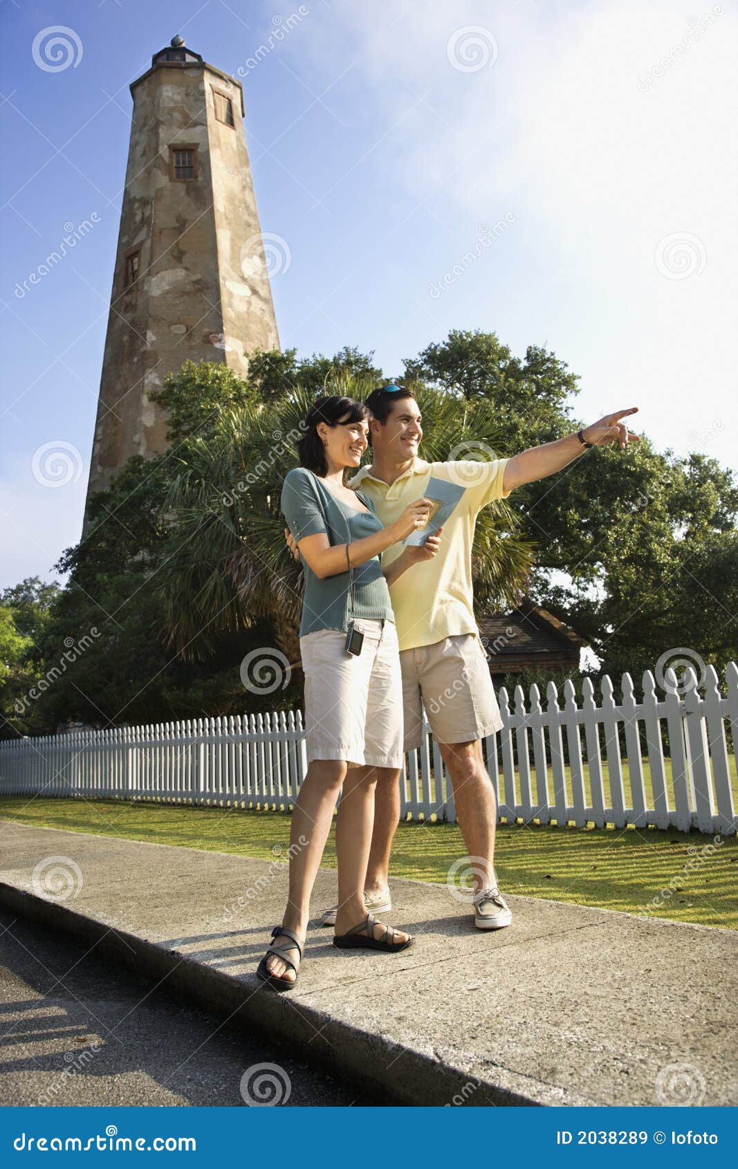 couple sightseeing by lighthouse.