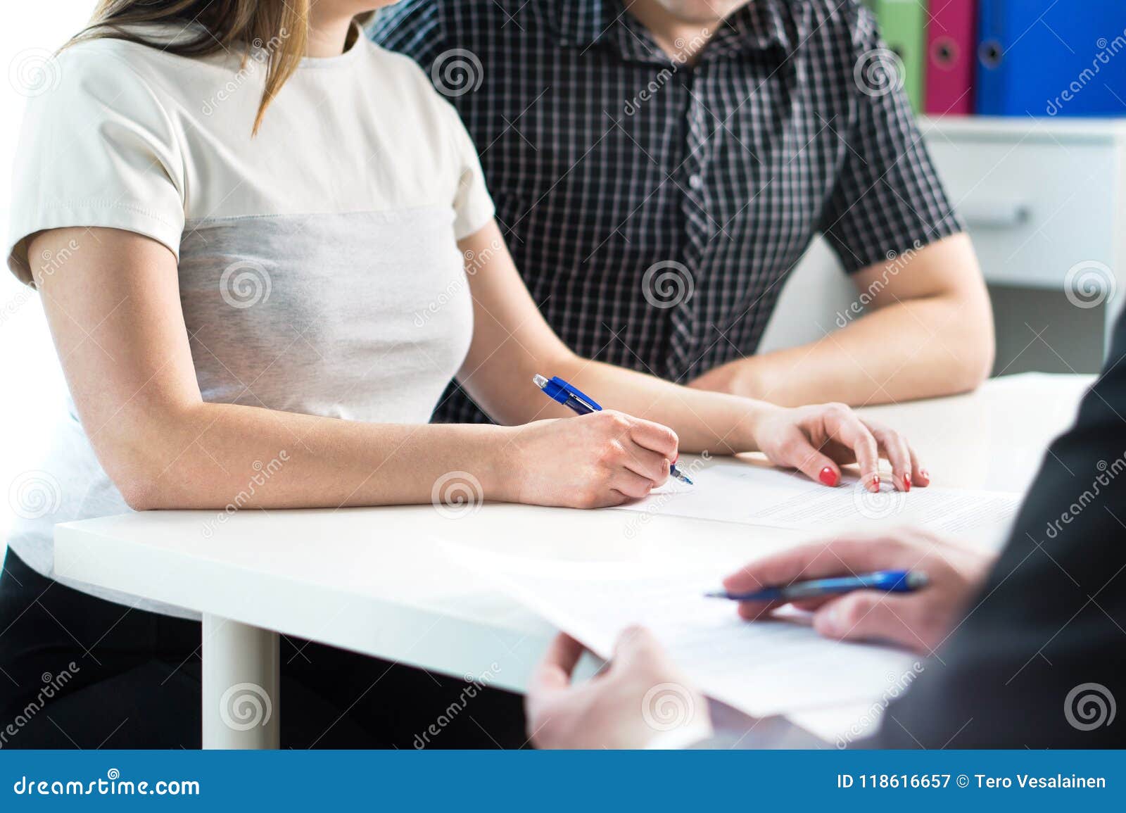 couple signing contract. legal document, health insurance.