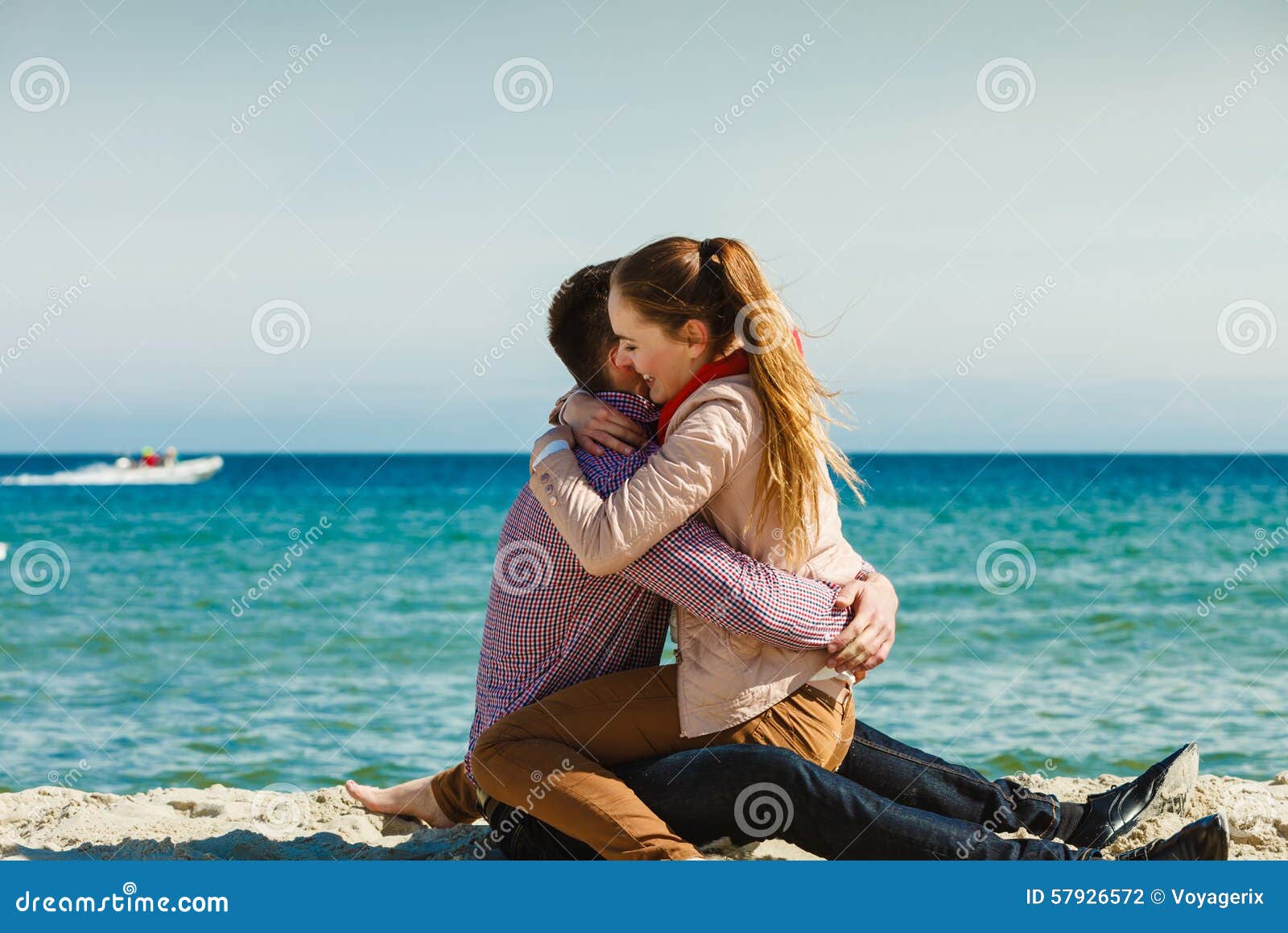 Couple Sitting on Beach Relaxing and Hugging Stock Photo - Image ...