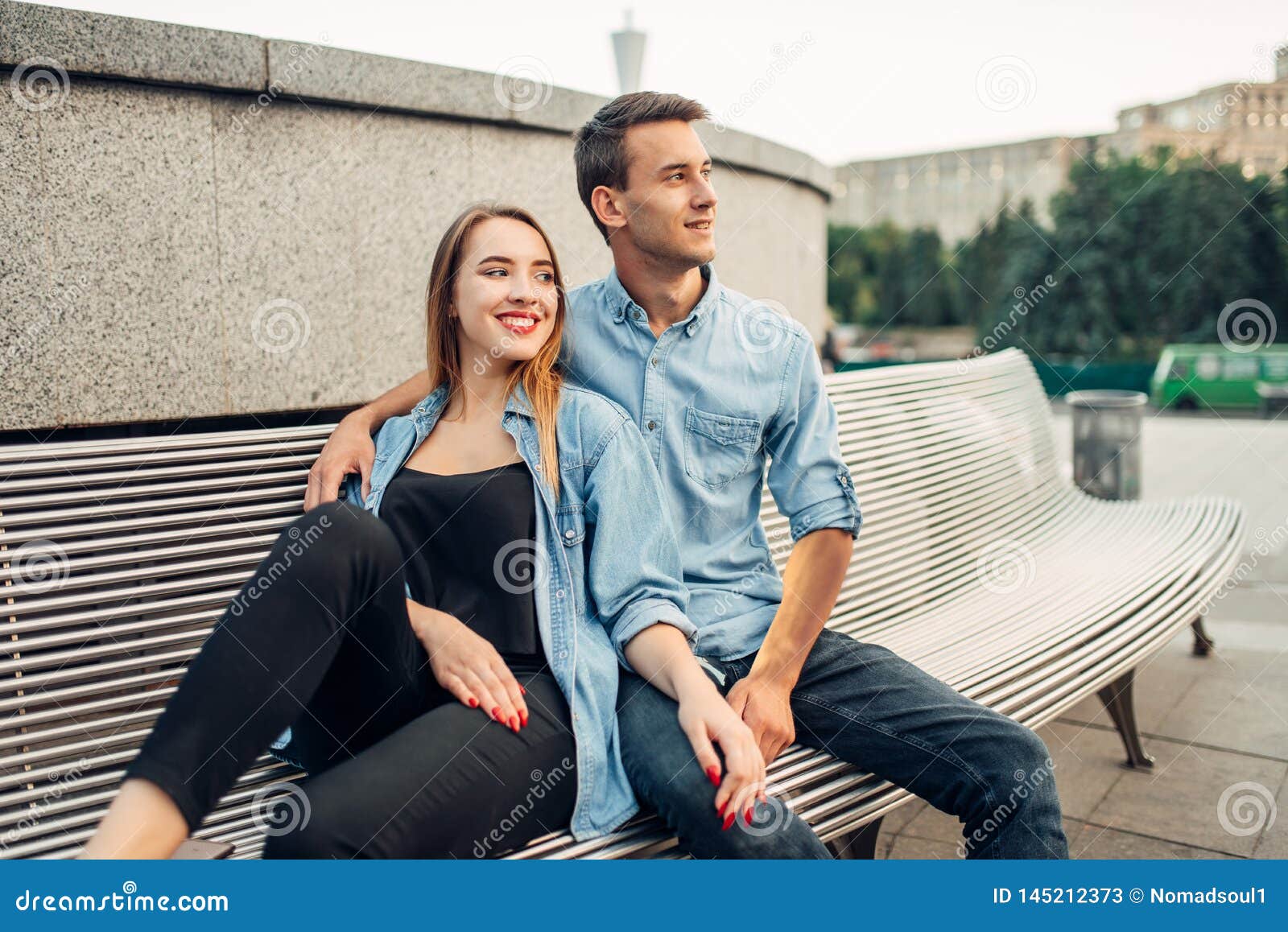 Love story of indian couple posed outdoor, sitting on bench together. Stock  Photo by ASphotostudio