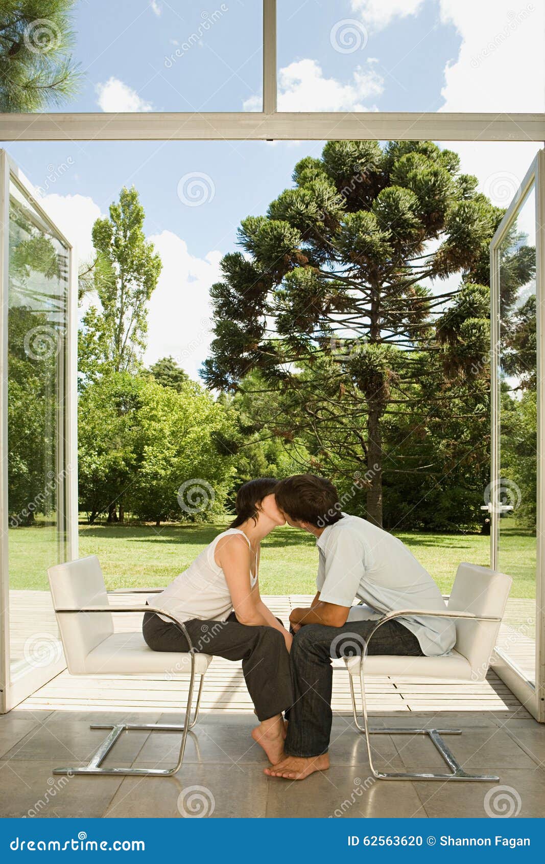 Couple Sitting in Chairs and Kissing Stock Photo Image of desire