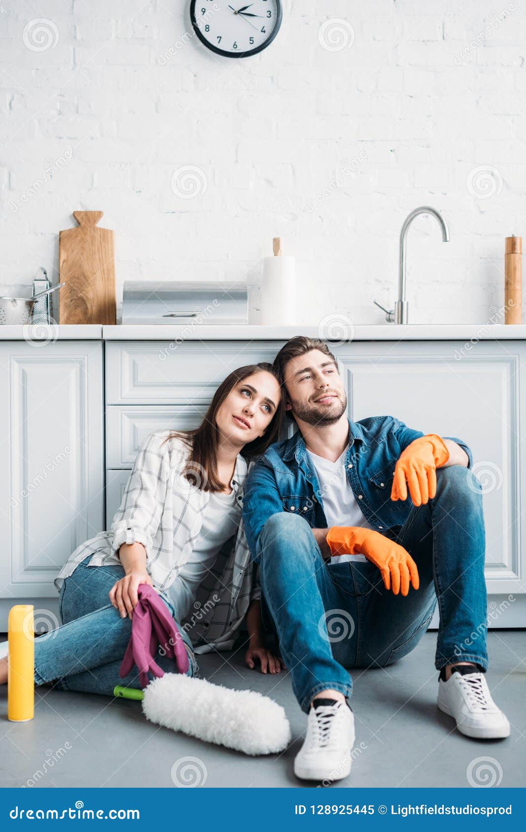 Couple Sitting On Floor And Leani