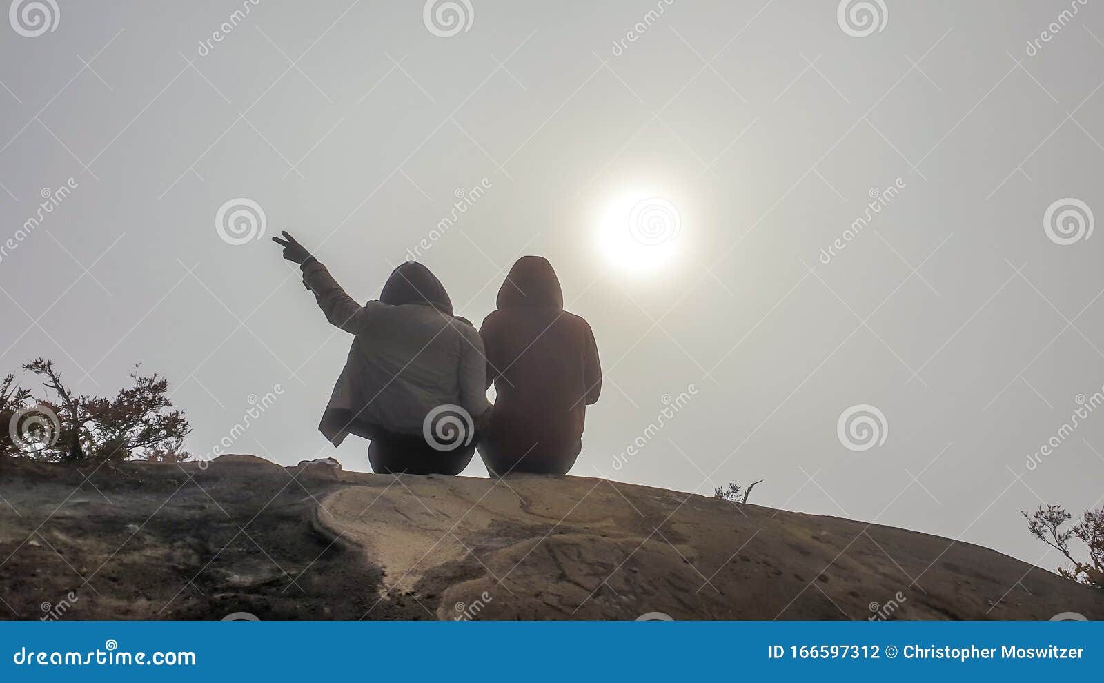 bajawa - couple sitting in between the clouds