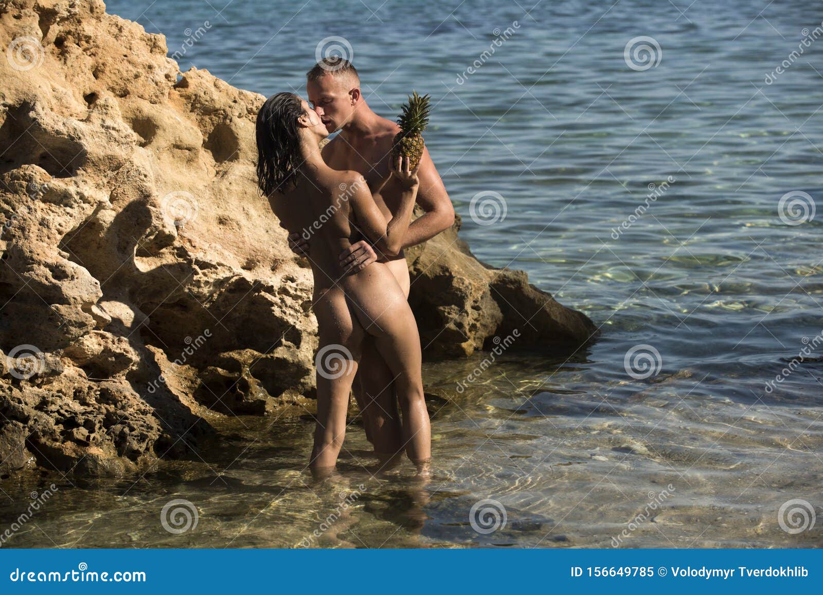 Beach Couple Kissing Naked - Couple Stand in Sea Near Reef and Kissing on Sunny Summer Day. Naked Couple  on Vacation Hold Pineapple Stock Image - Image of concept, hold: 156649785