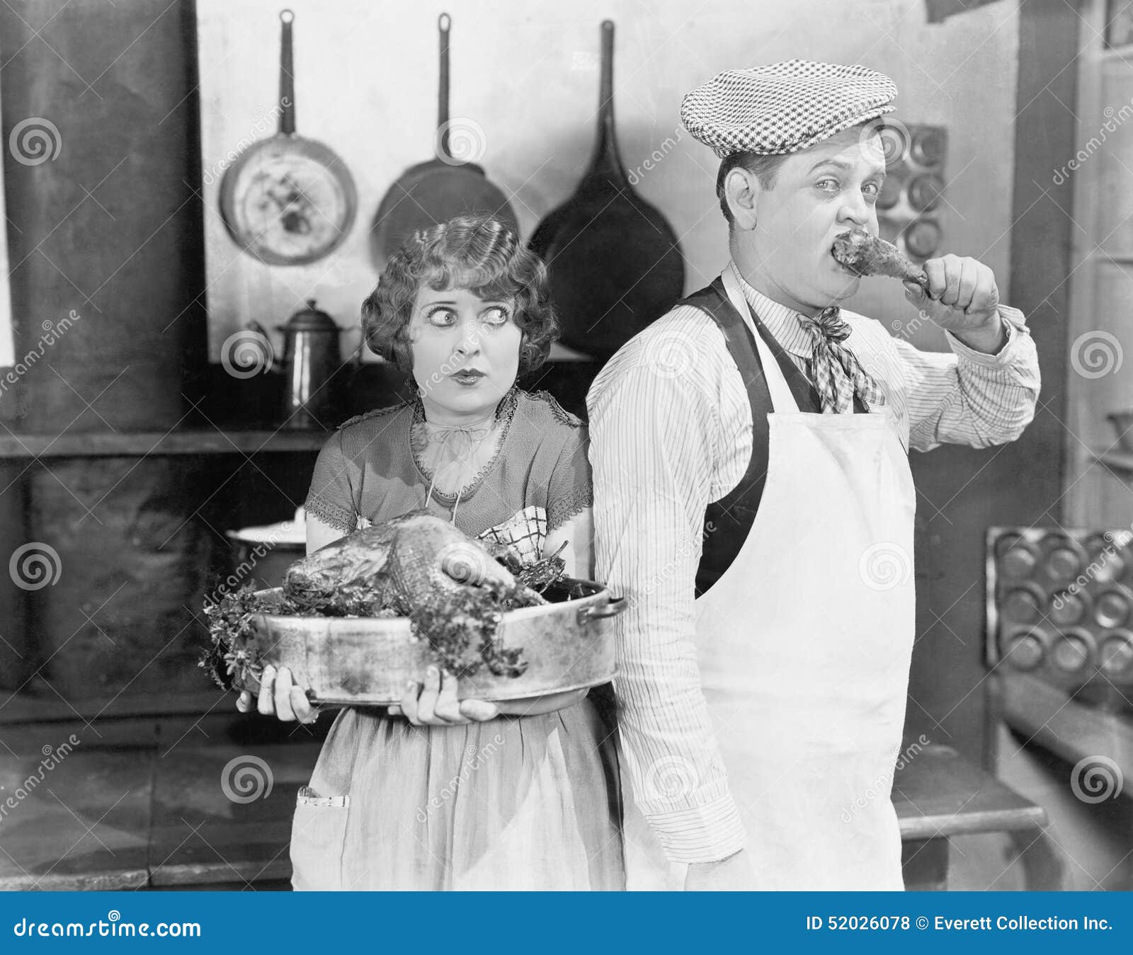 Couple Standing Together In A Kitchen With A Cooked Turkey Stock