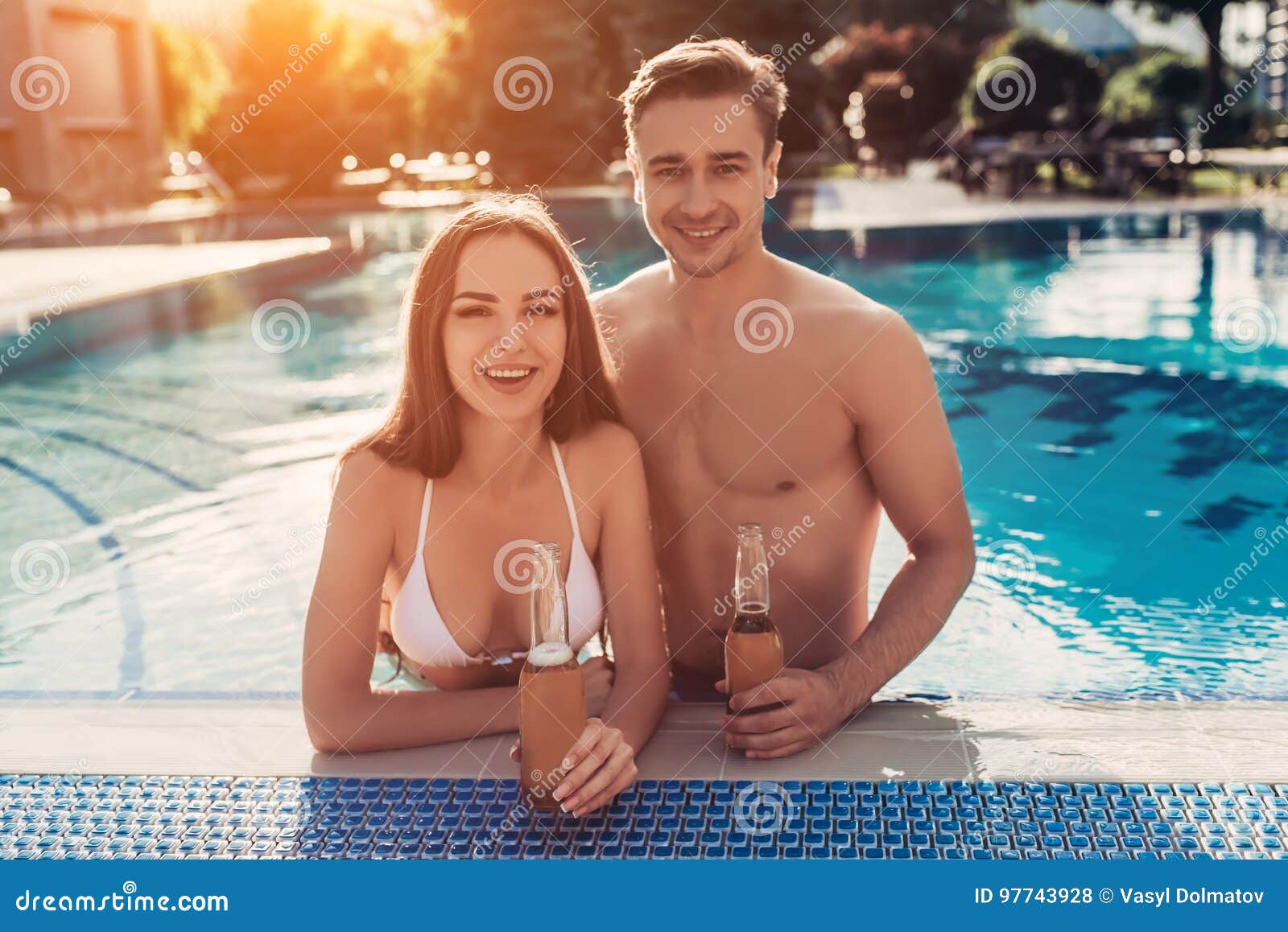 Young couple near swimming pool stock photo (127584) - YouWorkForThem