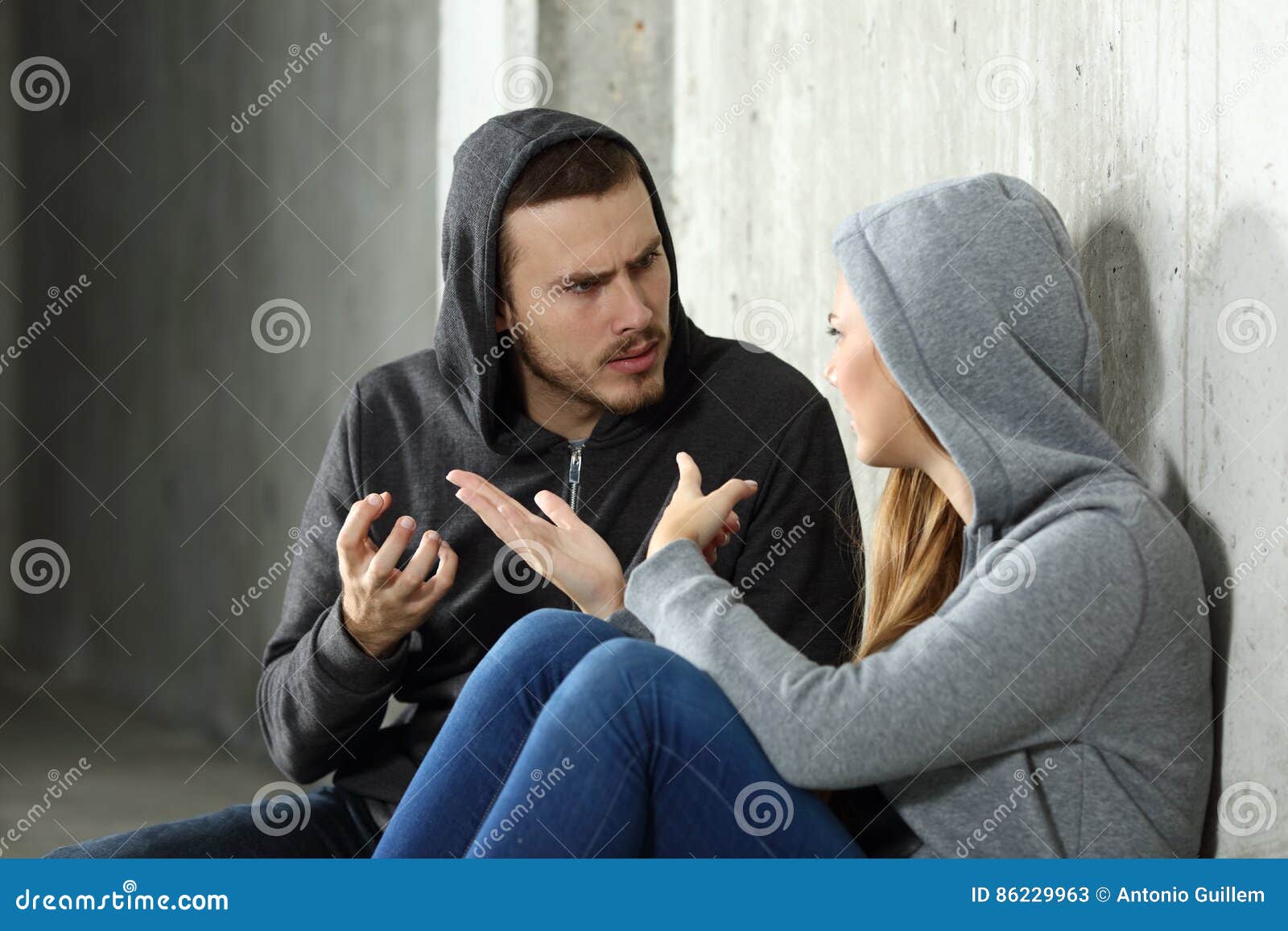 couple of teenagers arguing in a dark place