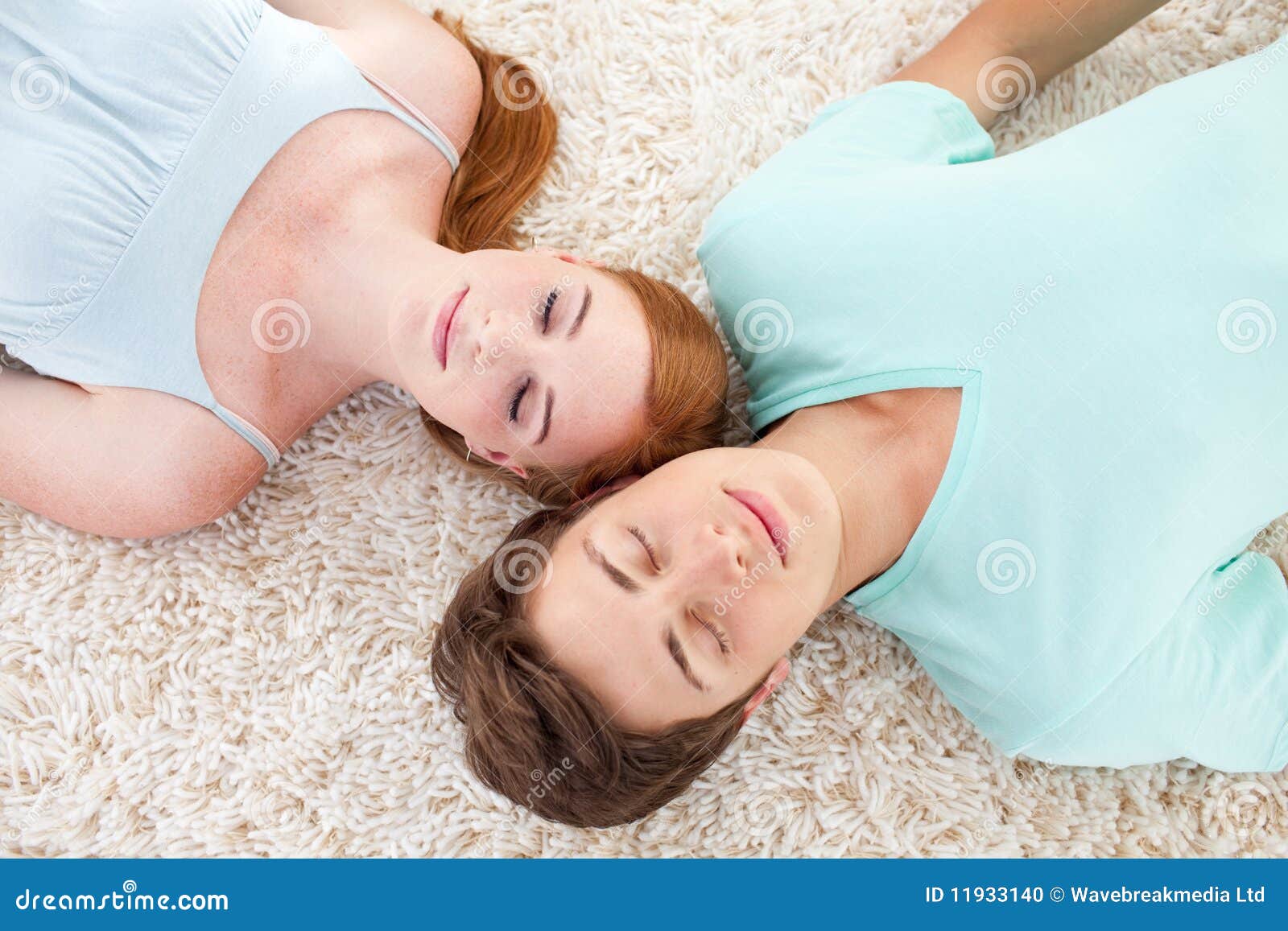 A Couple Of Teenagers Sleeping On The Floor Stock Photo Image Of