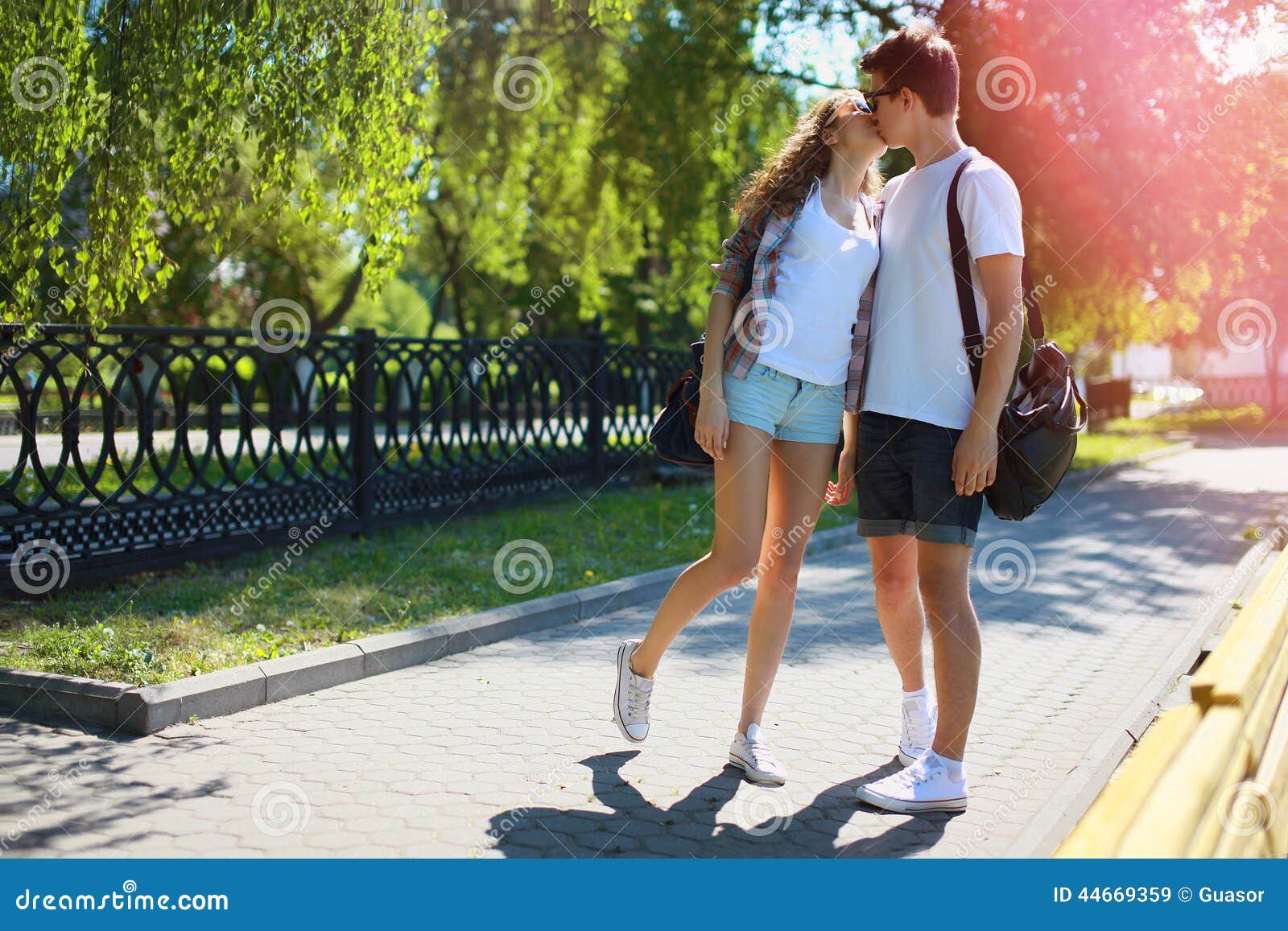 Couple Teens In Love Walking In The Park In Sum