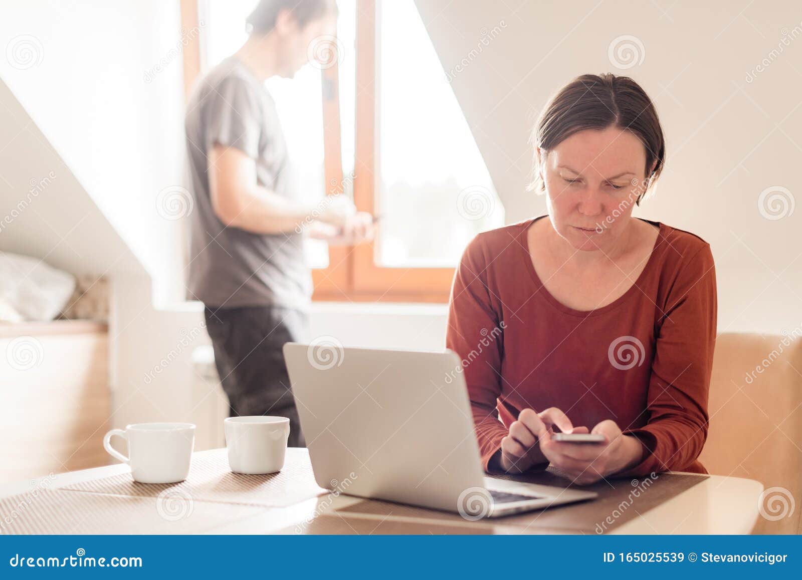 couple telecommuting, woman and man working in home office