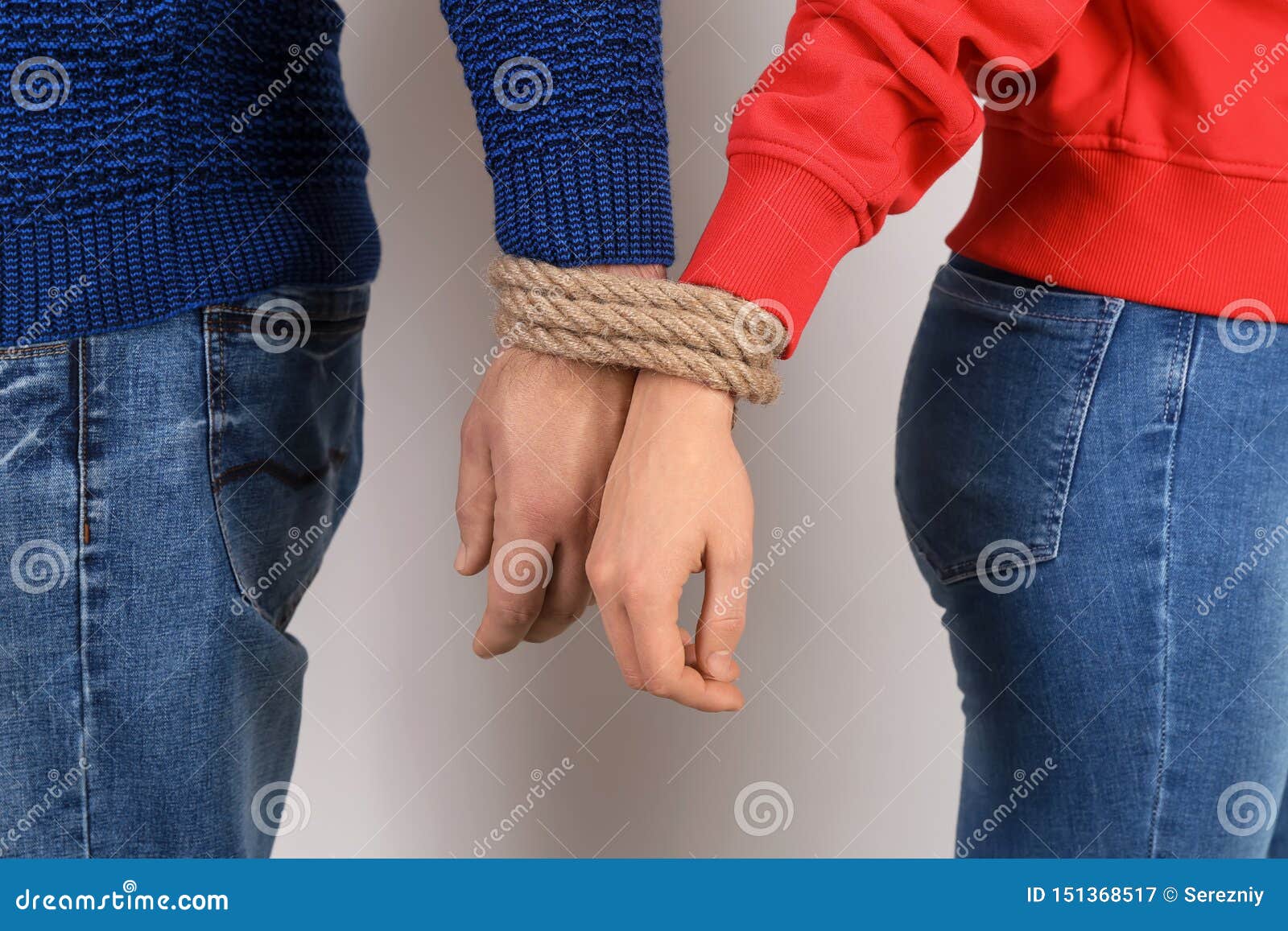 Couple With Tied Together Hands On Light Background Concept Of