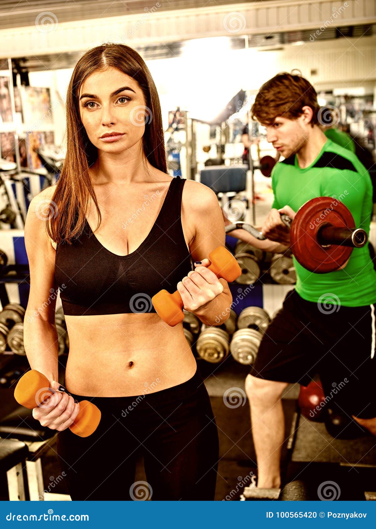 Couple Together Gym. Friends Workout with Fitness Equipment. Stock