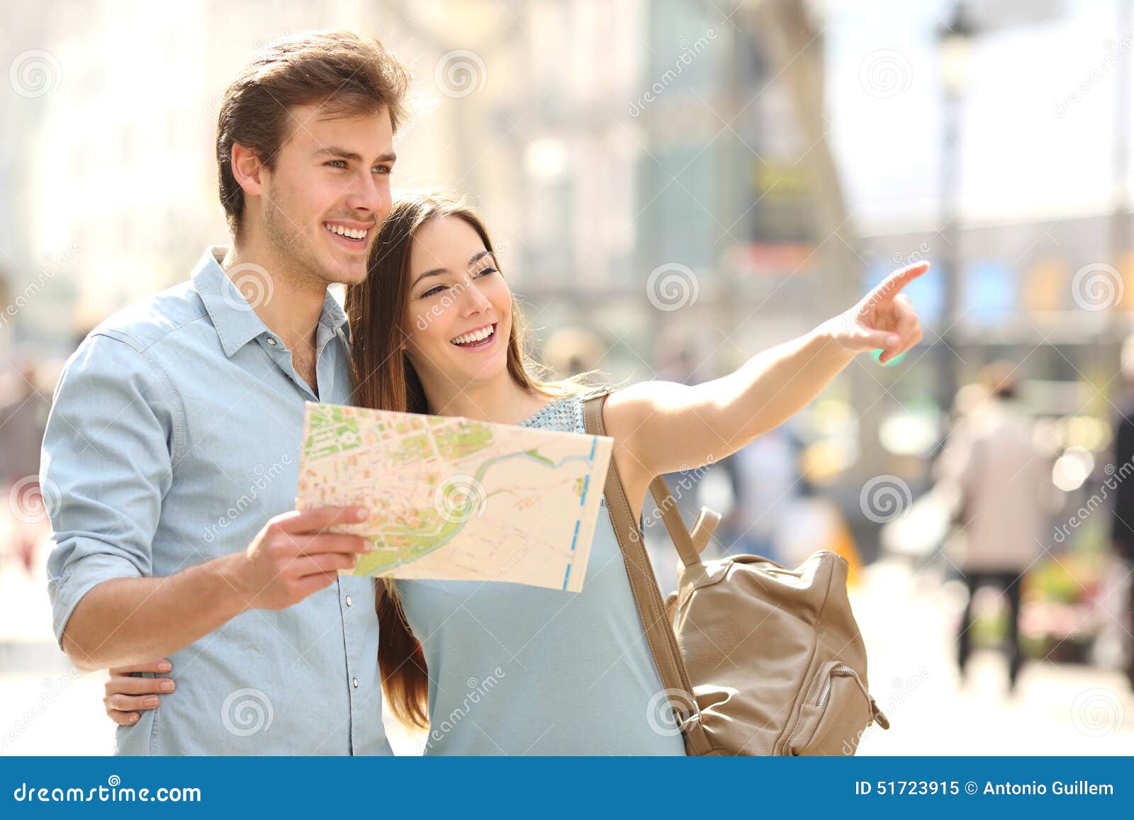 couple of tourists consulting a city guide searching locations