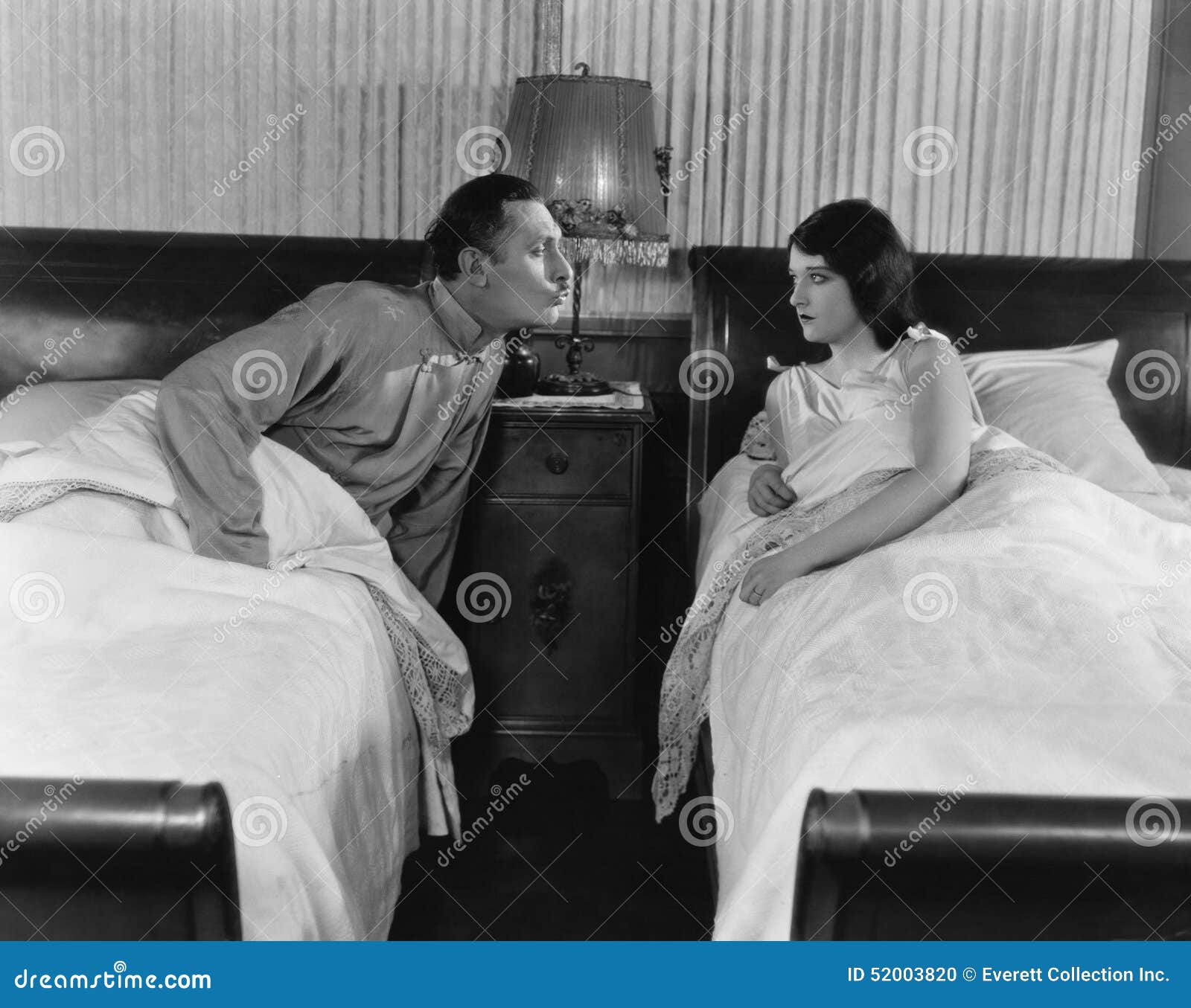 Couple in twin beds stock photo. Image of beds, bedtime 52003820