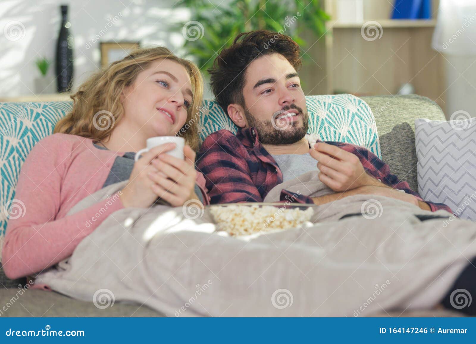 Couple Under Blanket on Sofa Watching Television Stock Photo Image of