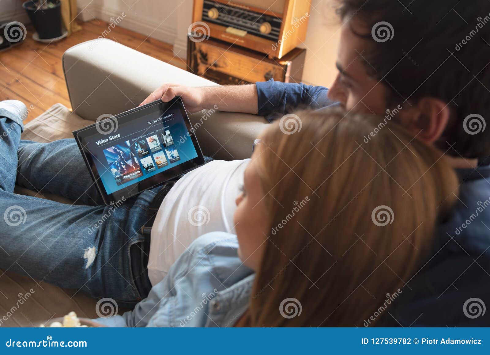 Couple Using Digital Tablet for Watching Movie on VOD Service Stock Photo