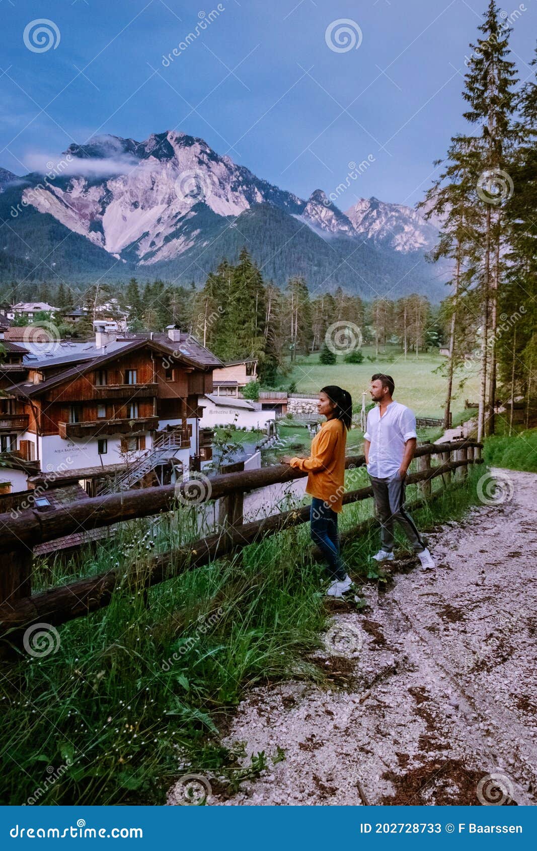 couple on vacation in the dolomites italy, small church during cloudy foggy weather, san vigilio di marebbe,south tirol