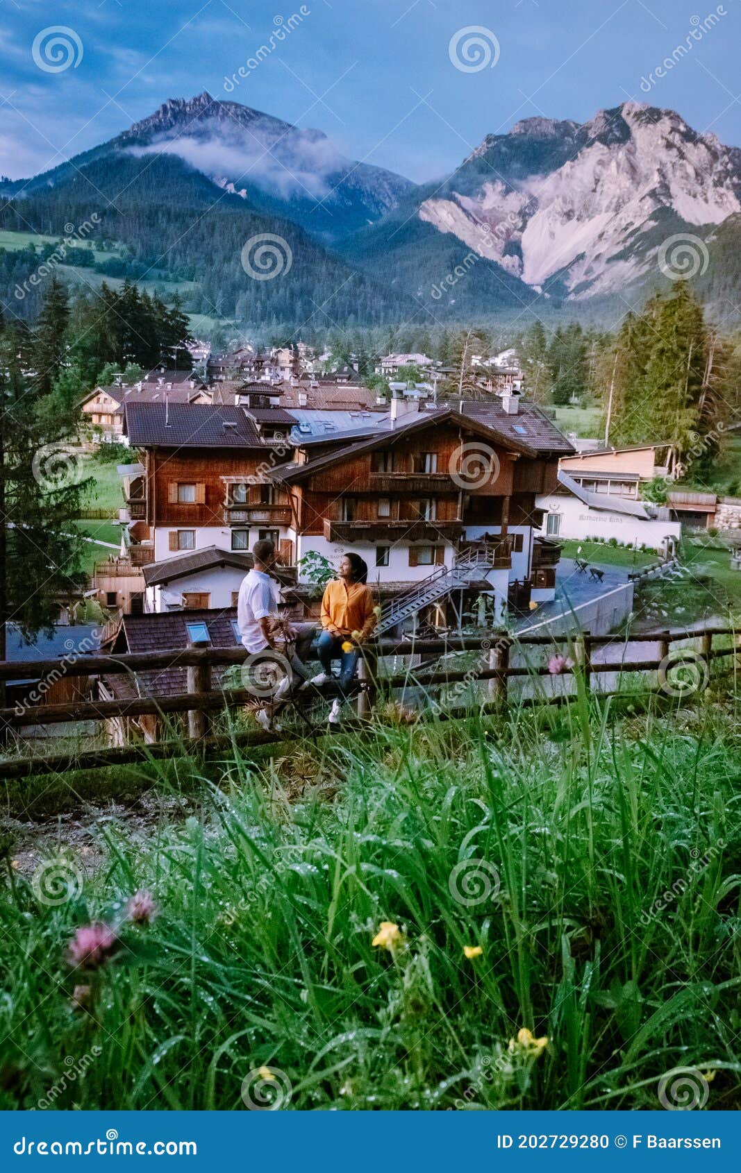 couple on vacation in the dolomites italy, small church during cloudy foggy weather, san vigilio di marebbe,south tirol