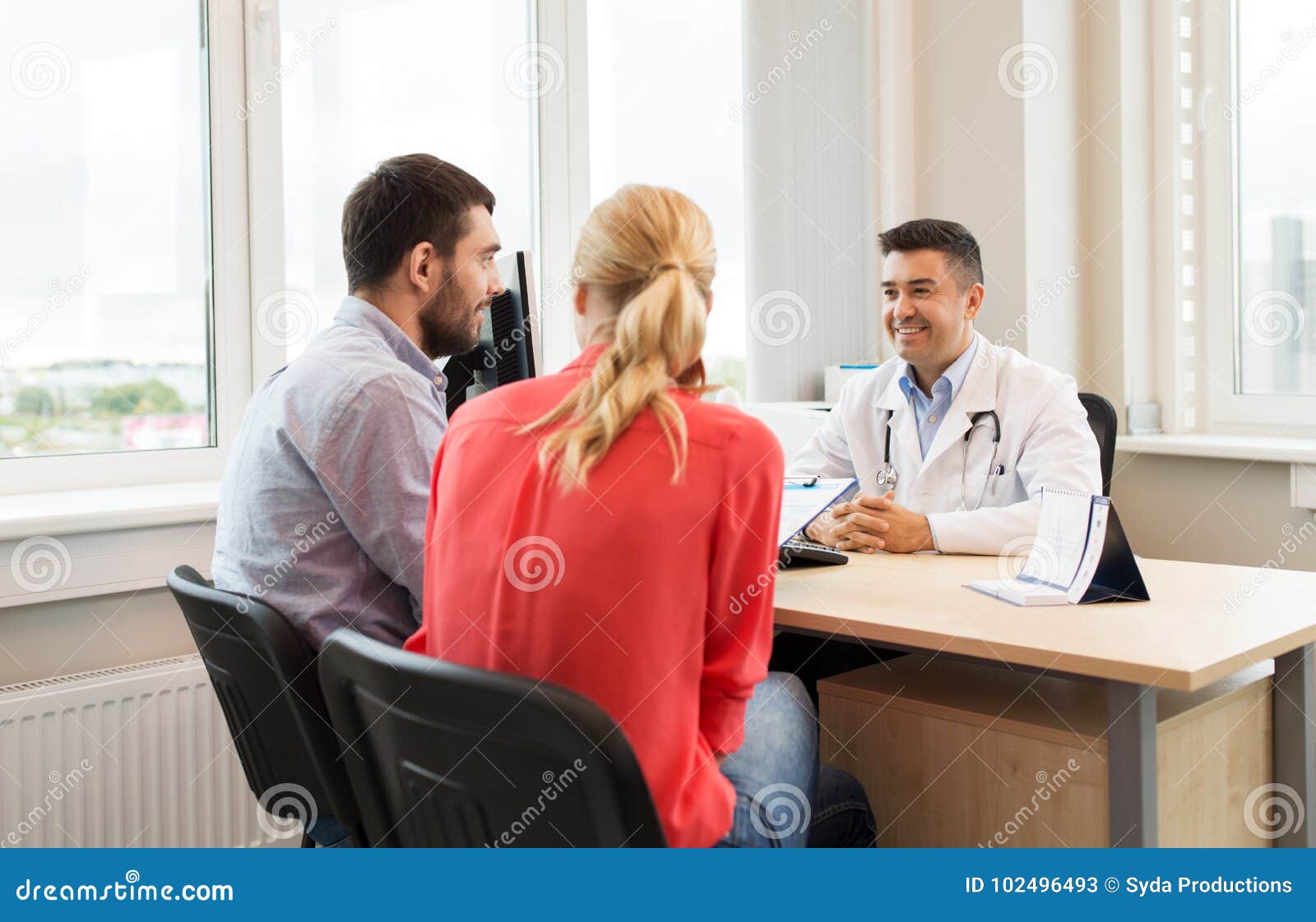 couple visiting doctor at family planning clinic