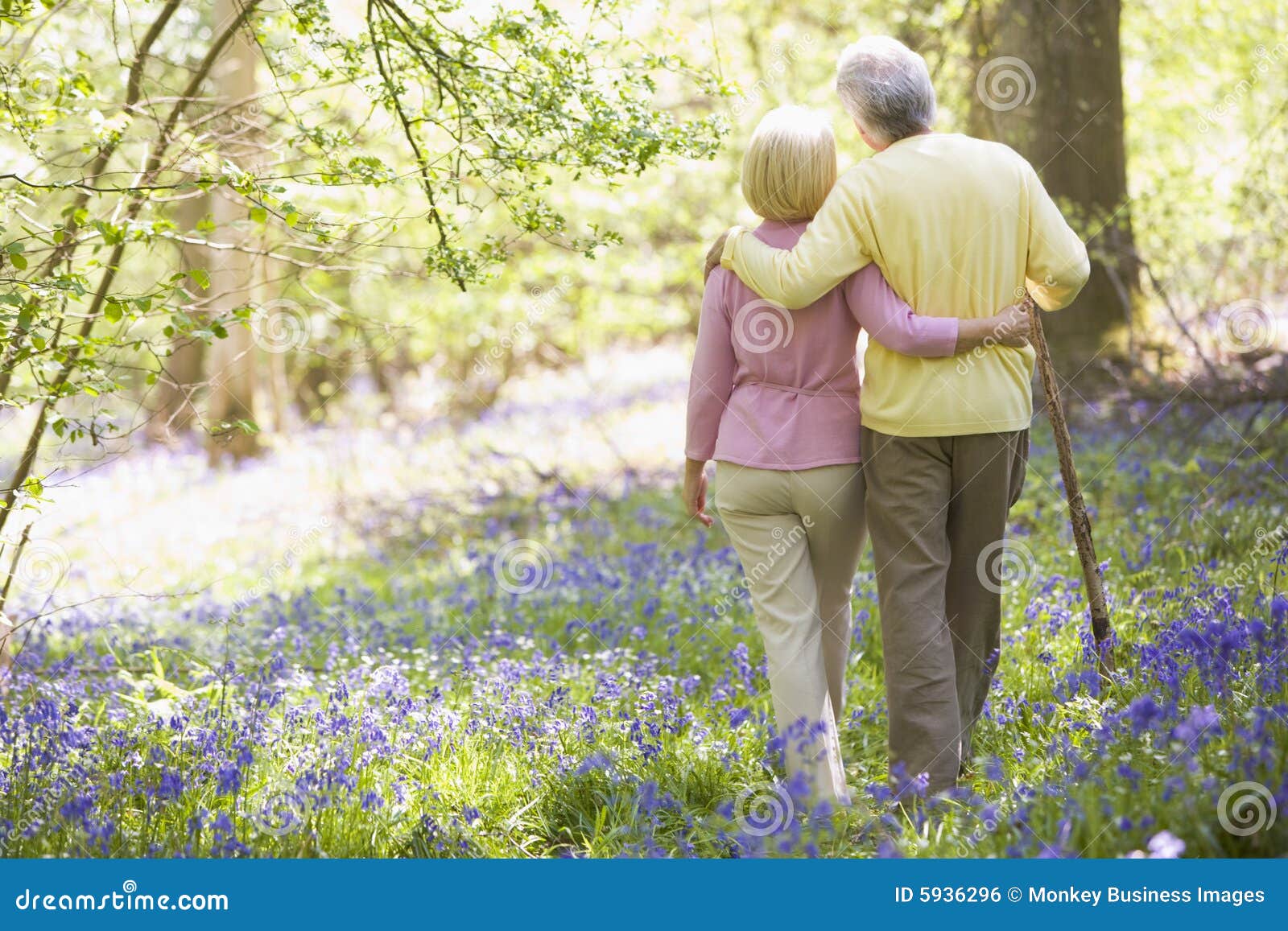 couple walking outdoors with walking stick