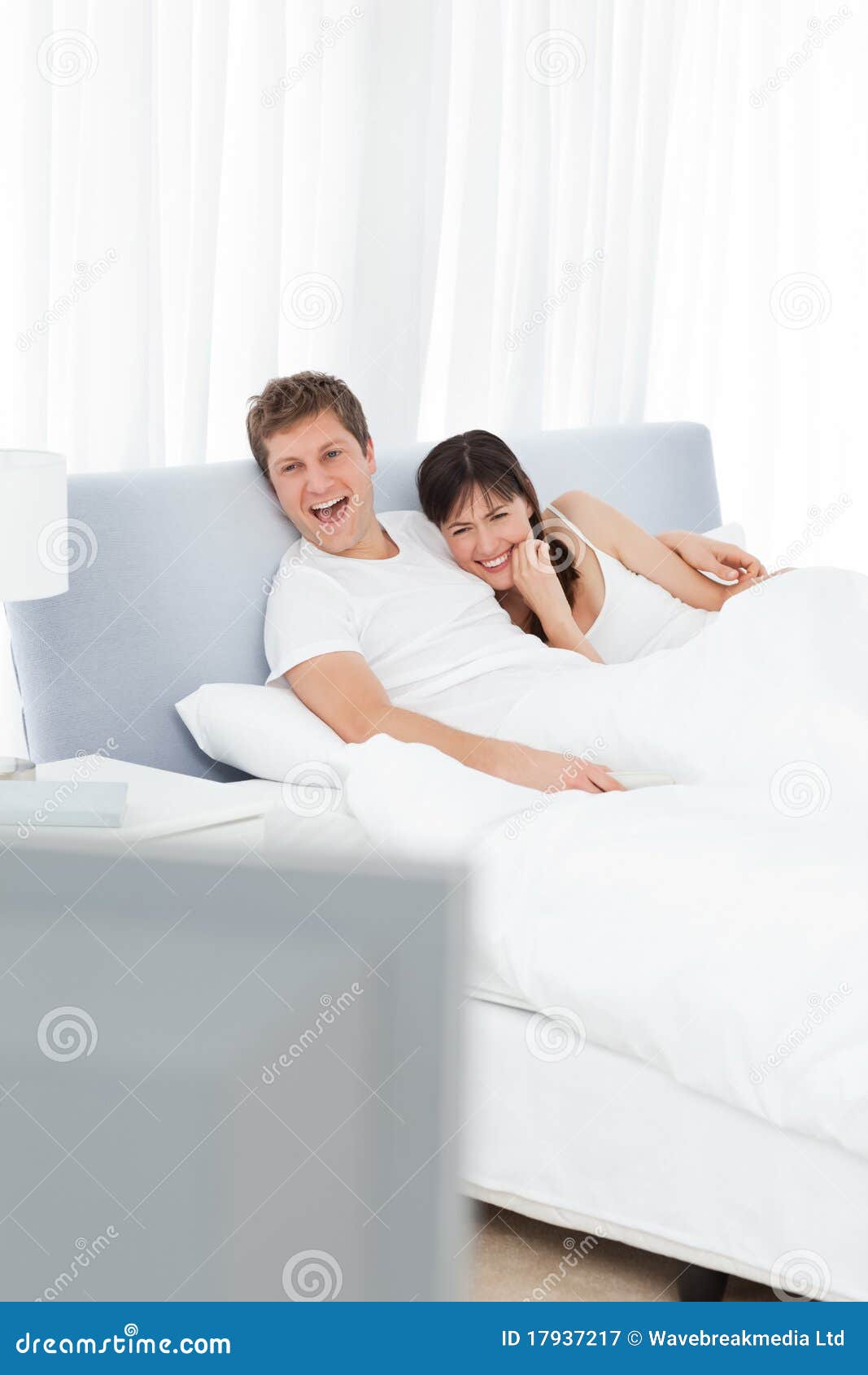 Couple Watching Tv in Their Bed Stock Image Image of female