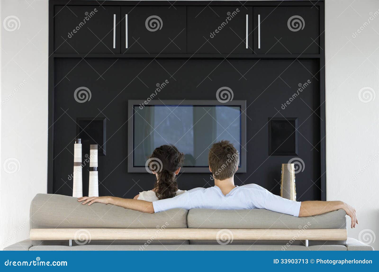 couple watching tv together in living room