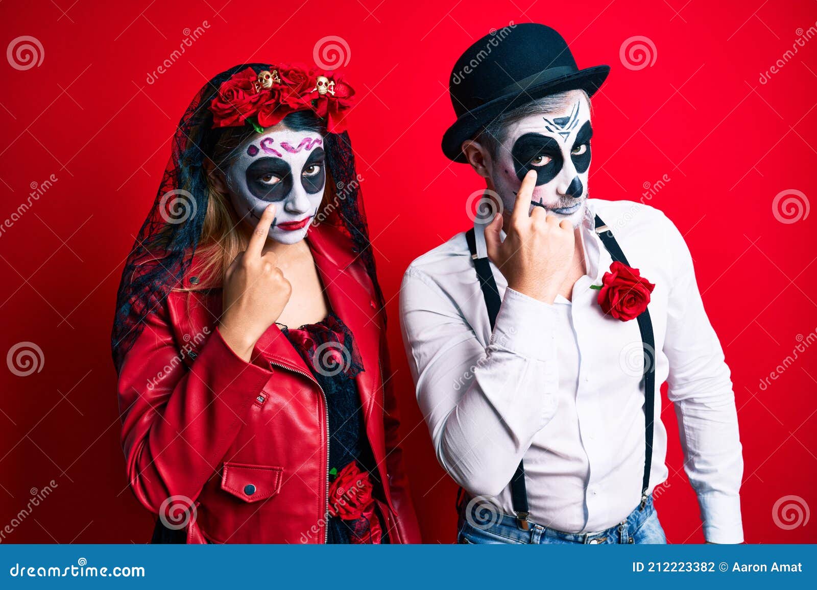 Couple Wearing Day of the Dead Costume Over Red Pointing To the Eye ...