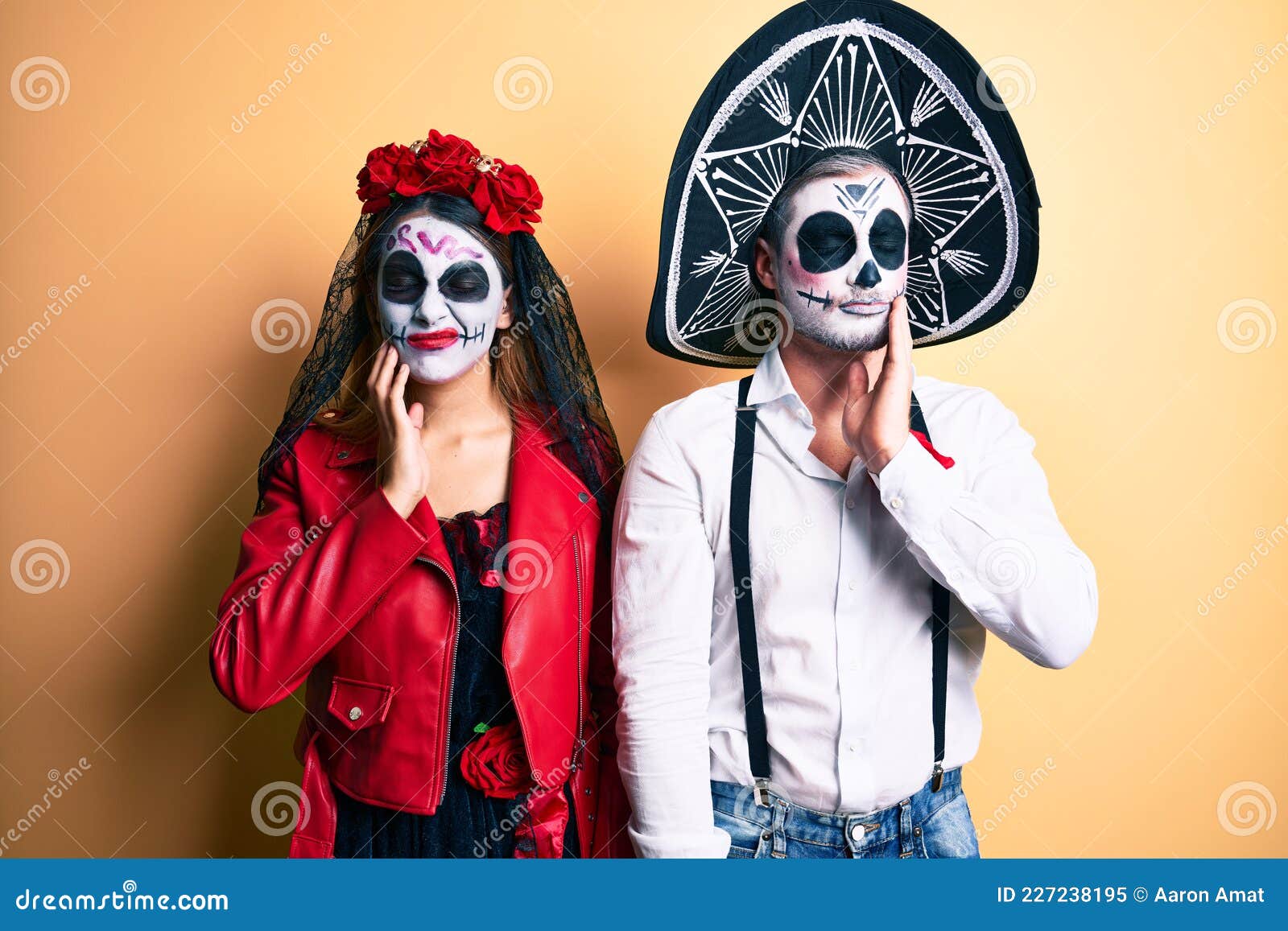 Couple Wearing Day of the Dead Costume Over Yellow Touching Mouth with ...