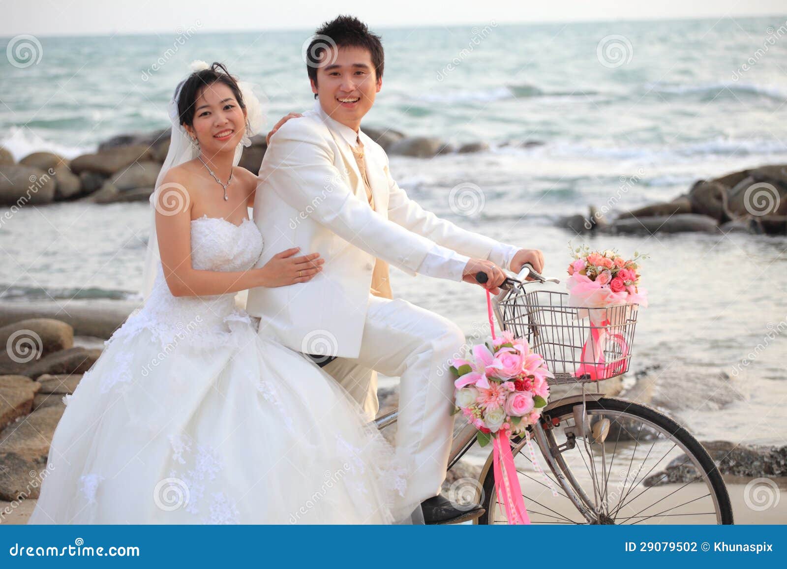 Photo of Beautiful outdoor couple shot with bride in sweetheart neckline  gown and groom in royal blue suit