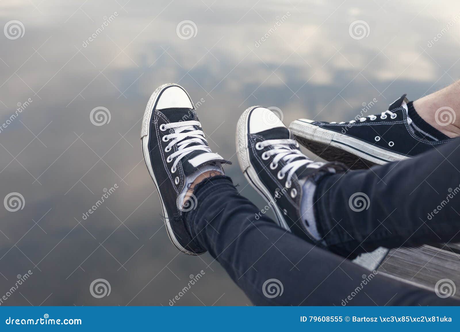 Couples Feet in Sneakers Relaxing by the Water Stock Image - Image of ...