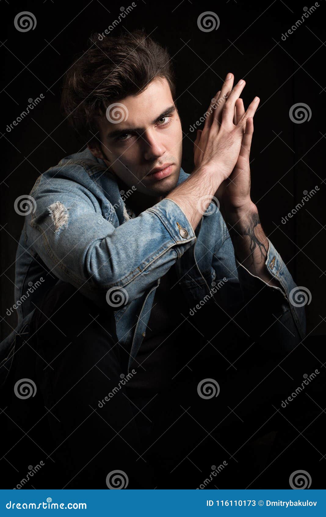 a courageous portrait on a black background. young handsome man