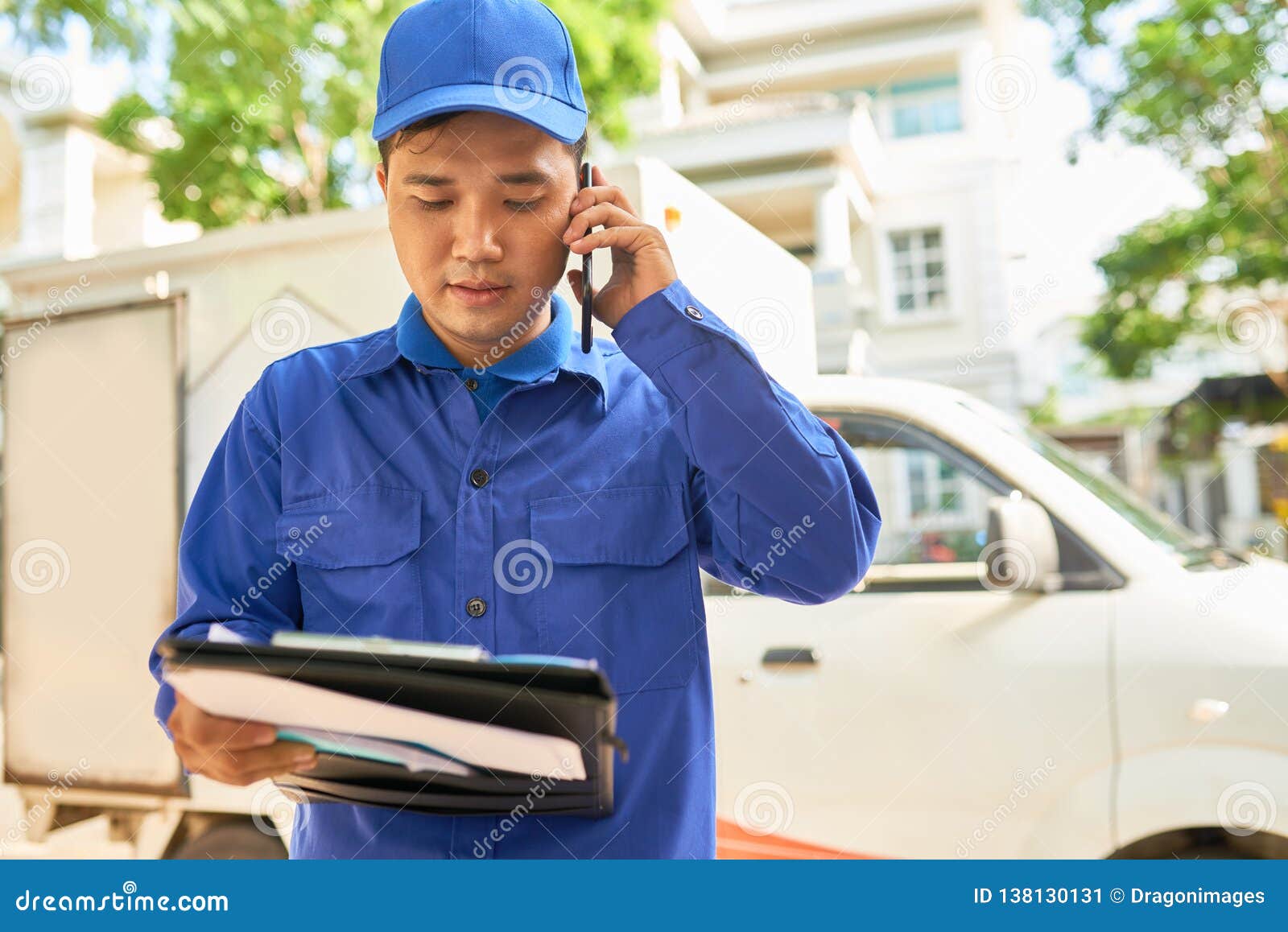 Courier calling client stock image. Image of post, document 138130131