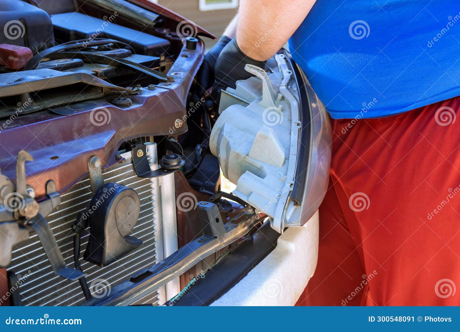 During Course of Automobile Repair, Mechanic Assembles a Headlight on