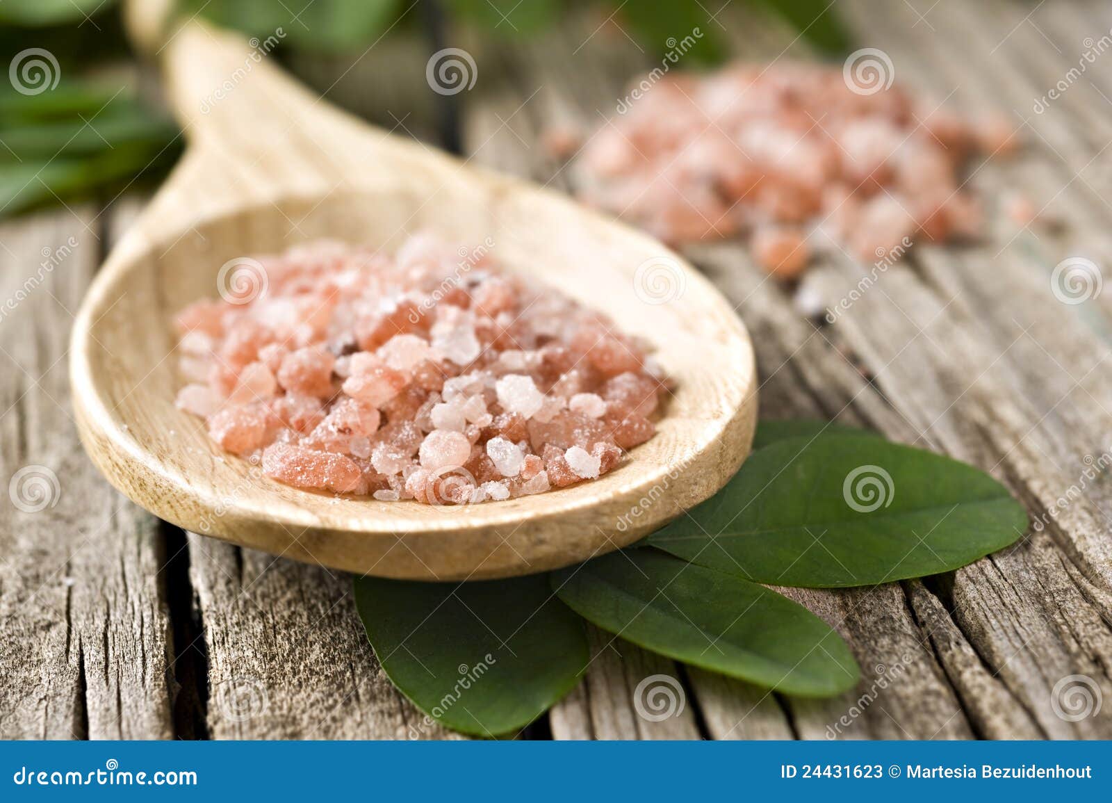 course pink himalayan salt on a wooden spoon