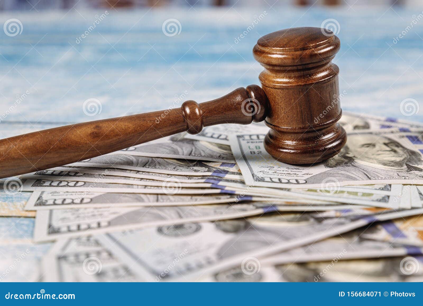 court gavel and money on blue background