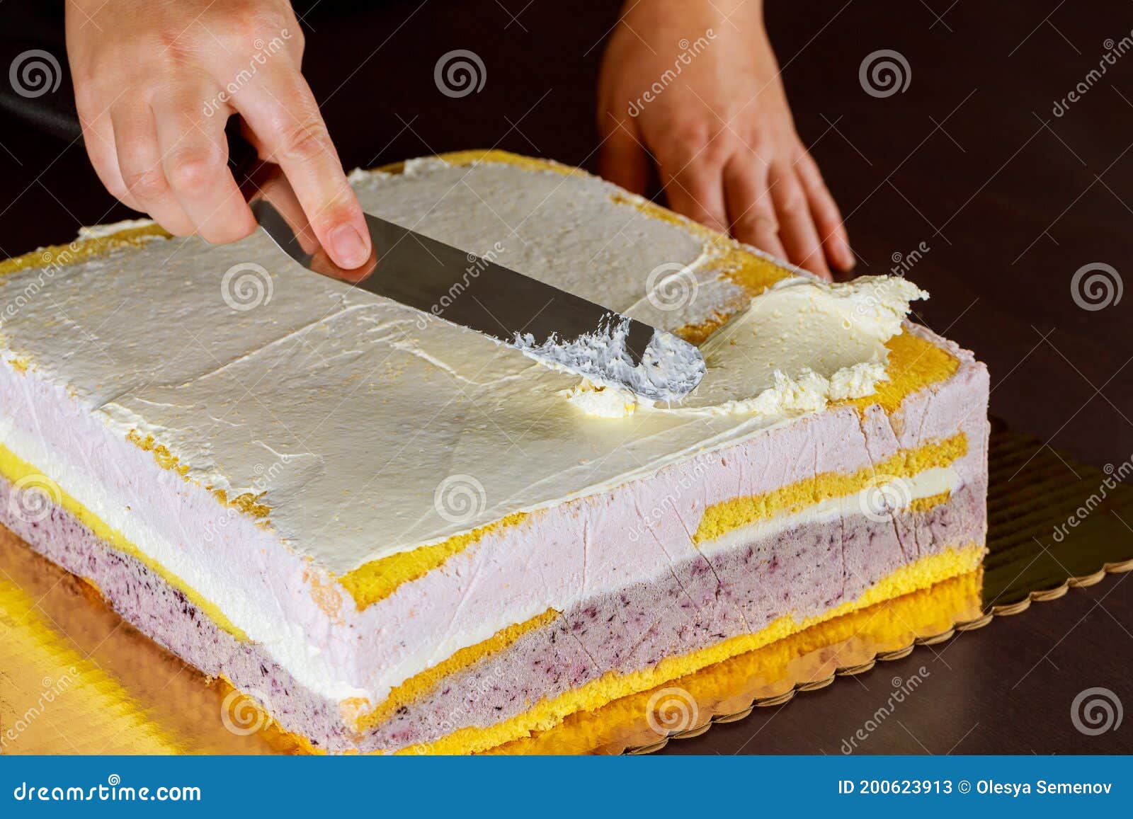 Covering Layer Cake with Icing or Cream. Making Layer Sponge Cake Stock
